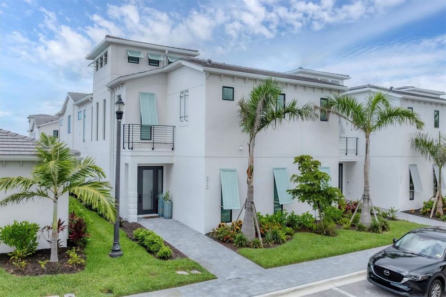 Available Now!  Stunning 2024-built FURNISHED home in premier gated community AQUA LAGOON, located near Sarasota Bay and 9 minutes from IMG Academy.  This two-story residence is steps away from AQUA's signature four-acre blue lagoon.  The main level of this home features a bright and airy open-concept layout with a chef's kitchen, formal dining room, oversized living room, flexible den/office space, and a cozy nook beneath the staircase. Upstairs, the primary suite offers a private balcony overlooking the pool and courtyard, an oversized walk-in closet, and a spa-inspired bath with dual vanities, walk-in shower, and freestanding Jacuzzi tub. Two additional guest suites, each with full bath and one with its own balcony, plus a second living room and a well-appointed laundry room complete the upper level. The tranquil outdoor oasis centers around a private courtyard with a salt-chlorinated pool with waterfall feature and covered lounge area. Additional features include a two-car garage and a Sonos sound system with room-by-room volume control.