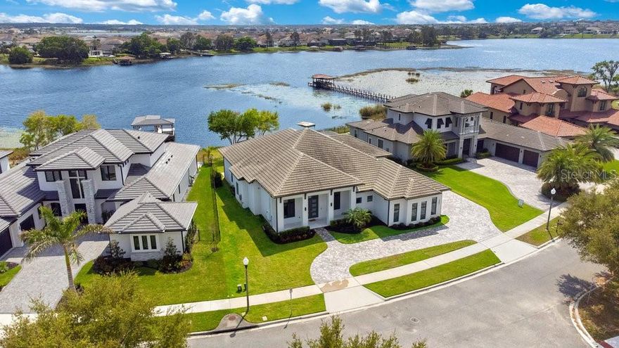 Get ready to enjoy the lake lifestyle in your custom Davila lakefront home poised on a cul-de-sac lot with 80 feet of pristine shoreline on Lake Hancock. This masterpiece of a home built in 2019 has it all with 4 bedrooms, 4 bathrooms, huge great room, office, and a large 3 car garage all on one level! The contemporary home was designed to enjoy the breathtaking panoramic views of Lake Hancock with the utmost comfort and privacy. The grand façade has contemporary architecture complimented with a halfmoon driveway, and large custom double entry door. Upon entry you will immediately notice 13’ soaring high ceilings in the foyer with chic porcelain floors throughout. Sit back, relax, and take in your beautiful lake views from the great room which is open to the kitchen and casual dining space. The chef’s kitchen is a dream come true with a large center island, breakfast bar seating, subway tile backsplash, pendant lighting, walk-in pantry, cooktop, stainless steel appliances, vented hood, flex refrigerator, beverage refrigerator, and built-in oven. The elegant dining room is perfect for those formal occasions with its own wainscotting. Work from home in peace with your own office away from the living areas. The primary suite has its own seating area with amazing lake views including a large built-in walk-in closet, spa like bathroom including a glass shower, tub, and dual vanities. All secondary bedrooms are en-suites with plenty of closet space. Relax and enjoy captivating lake views within the serenity of the expansive outdoor living area that is fully screened with your heated saltwater infinity edge pool and raised spa surrounded with premium deck pavers. The covered lanai includes an amazing fully equipped summer kitchen for those perfect summer barbeques and get togethers with loved ones. Additionally, the neighborhood has its own community pool, parks, and playground. Winter Garden offers great schools, close proximity to restaurants, shopping, and attractions. Be prepared to enjoy the extraordinary lake lifestyle this property offers to anyone that passes through its doors. Be sure to click on the virtual tour links. 

<iframe width='853' height='480' src=https://my.matterport.com/show/?m=mcPnQ56TiV6&mls=1></iframe>