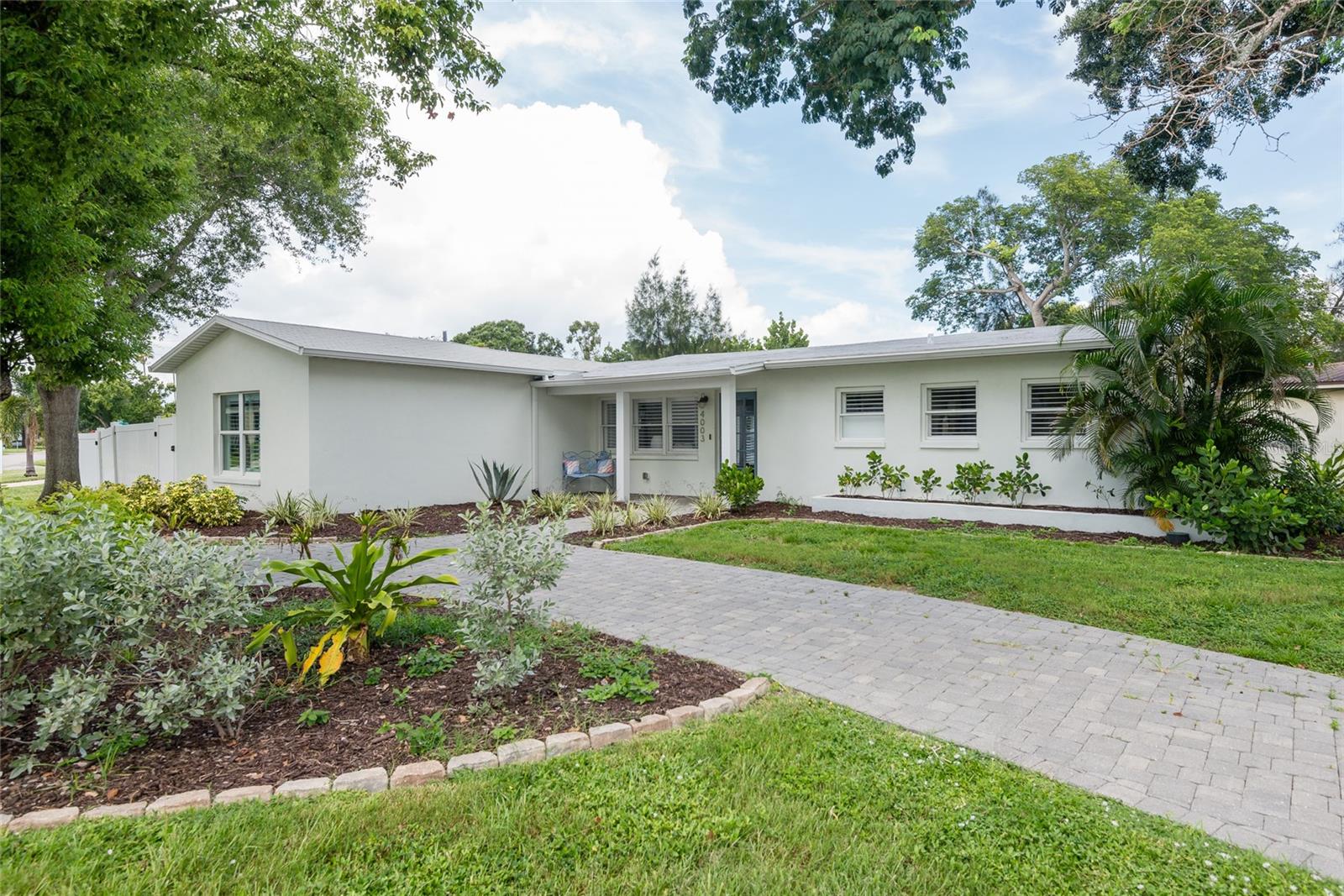 Beautifully updated in 2018, this 3-bedroom, 2-bathroom home sits on a spacious 77' x 105' corner lot in a quiet neighborhood. Features include a circular driveway and an open-concept layout connecting the kitchen, dining, and living areas. The kitchen offers shaker cabinets, quartz countertops, and stainless steel appliances.
French doors off the dining room open to a generous backyard deck—ideal for entertaining. The split floor plan offers privacy, with the primary suite featuring a walk-in closet, modern en-suite bath, and its own private deck. Two additional bedrooms and a renovated full bath are located on the opposite side of the home.
Additional highlights include updated landscaping, mature shade trees, a dedicated laundry room, dual HVAC systems for enhanced efficiency, and side yard access with space to store a boat. Conveniently located near parks, top-rated schools, and major roadways including Gandy Blvd, Dale Mabry Hwy, and the Selmon Expressway.