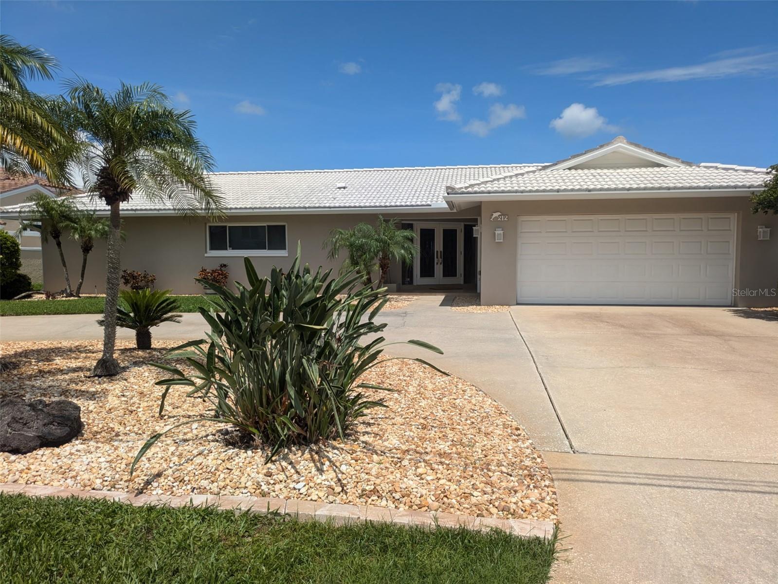Beautiful Waterfront location in desirable Harbor Bluffs. Boater’s paradise with 4 beds 3 full baths and 2 car garage. Wonderful double door entry into the spacious living room where you are immediately greeted with a lovely waterfront view. Ideal floor plan offers a centrally located kitchen with pass through window to the pool area and also leads to the dining room / family room. The large primary bedroom has a full en suite bathroom. The adjacent bedroom could also be used as a nursery, office, or den. Home features a split plan layout with additional 2 bedrooms and full bathroom off the dining room. Large laundry room with sink has access to the 2 car garage. Oversized, solar heated, screen enclosed swimming pool has new equipment and color LED pool light. Primary suite, living room and dining room all have sliders providing direct access to the large paver deck which is perfect for entertaining. Watch the dolphins play and enjoy gorgeous sunsets! Property boasts 88 feet of protected intercoastal waterfront with new seawall and new dock installed in 2022. Deco Lift has recently been serviced and is ready for your boat!! Additional features include: Roll down hurricane shutters and irrigation system.
Newer 4 ton air conditioner (2022). Newer water heater (2021) Circular driveway offers ample parking. Move in condition. Room dimensions are approximate and should be verified by buyer. Home warranty provided.