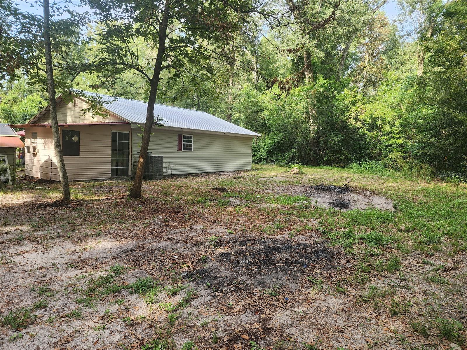 Beautiful rural property One mile from the Suwannee river, and 5 miles to beautiful Fanning Springs .,At the end of the road, very quiet, and private property. roof 2018, water heater approx 2013, central heat and air 2023, water softener 2022, 2 RV hookups. Garage 577 sq ft with water, power, and insulation. Garage could be converted to a potential mother in law suite. property fully fenced. Fiber ready internet.
