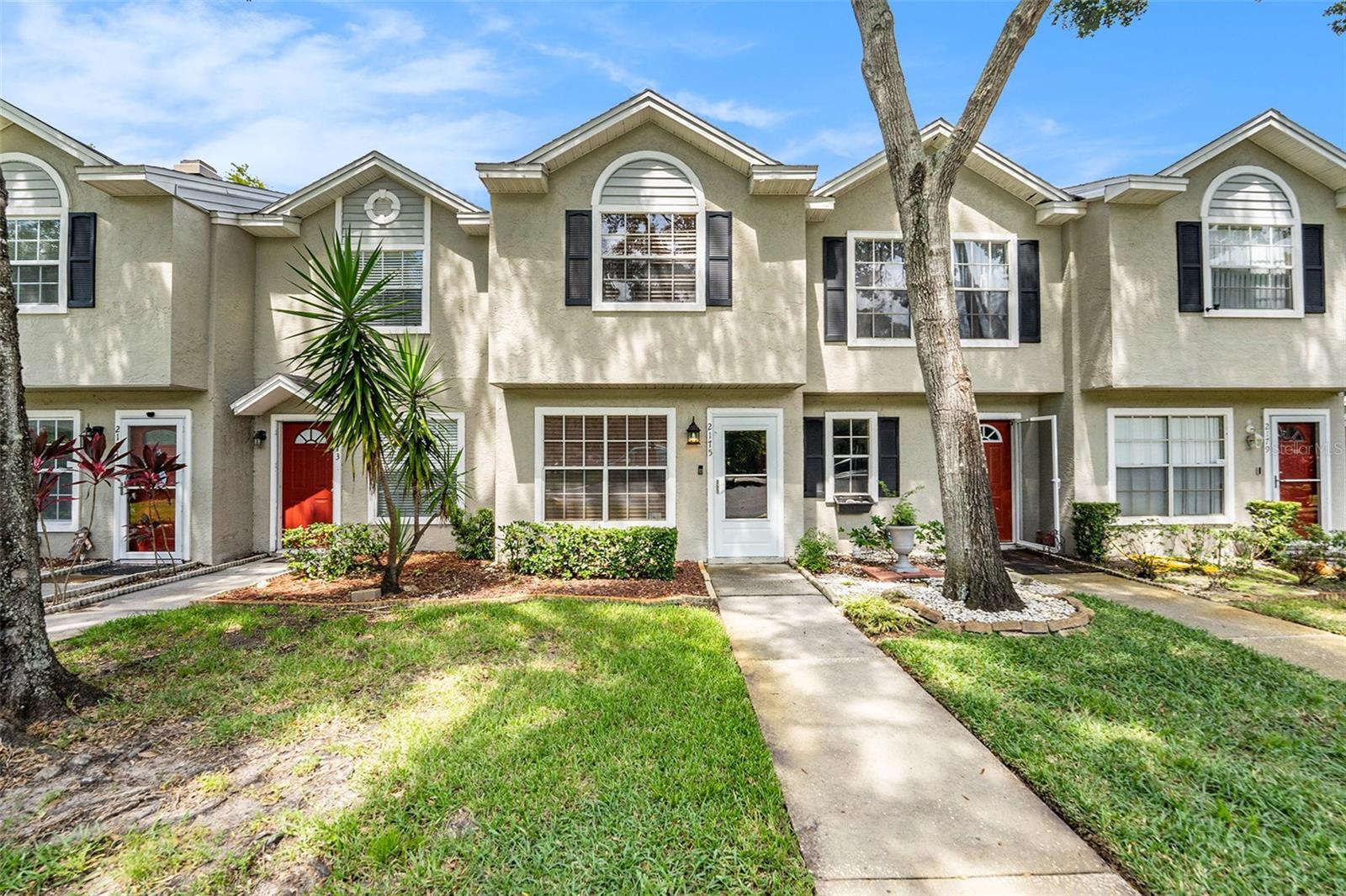 Assumable interest rate below 4%! Modernized throughout, this 2 BR/2.5 BA townhome in the gated Fox Chase community blends style and comfort. The updated kitchen showcases quartz countertops, white solid-wood cabinetry, stainless steel appliances, tile flooring, and a pantry. Upstairs, two spacious primary suites each feature a private bath with updated showers. A custom wood staircase adds charm with storage cleverly tucked beneath. The main level includes a dining area with built-in bar, family room, and half bath. Relax on the screened porch overlooking a serene conservation area with laundry and storage. The building’s roof was replaced just two years ago; HVAC 2018. HOA maintains exterior and lawn care, plus amenities. Nestled on a quiet cul-de-sac near shopping, dining, top schools, Honeymoon Island, and Gulf beaches, this Palm Harbor gem is move-in ready.