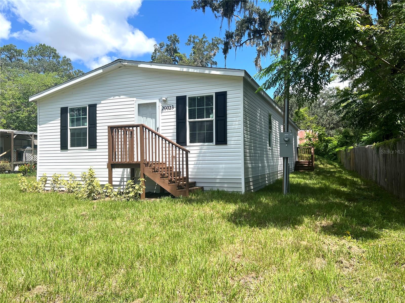 Discover the perfect blend of AFFORDABILITY and comfort with this NEWLY constructed (2025) manufactured home, offering nearly 1,400 square feet of thoughtfully designed living space — all on YOUR OWN LAND with NO lot rent and NO HOA. This is an incredible opportunity for homeowners who want to enjoy the benefits of ownership without the extra monthly fees.
Inside, you’ll find a smart split-bedroom layout with 3 bedrooms and 2 full baths, including a spacious owner’s suite with a walk-in closet and private bath. The open floor plan is designed for today’s lifestyle, featuring durable, no-carpet flooring throughout for easy maintenance and allergy-friendly living.
The kitchen is a standout, boasting plentiful cabinetry, generous counter space, and a walk-in pantry. Ideal for anyone who enjoys cooking or entertaining. A separate dining area flows into a large living room, giving you plenty of space to gather with friends.
Step outside to a low-maintenance yard where you can create your own outdoor retreat. The property is situated in a tree-lined neighborhood that offers convenience as well as value. Downtown Brooksville, shopping, dining, and medical services are just minutes away.
Move-in ready and waiting for you, this home provides the rare combination of modern style, comfort, and land ownership at an affordable price. Schedule your private showing today and see the difference for yourself.