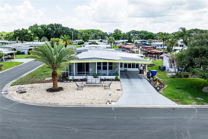 CANAL FRONT HOME with serene water views on the Lake Harris Chain of Lakes! This well-maintained 2-bedroom, 2-bath home sits on a corner lot in the 55+ Imperial Terrace East community and offers comfortable waterfront living with no lot rent — you own the land. The bright open floor plan connects the living, dining, and kitchen areas, while the spacious enclosed Florida room showcases peaceful canal views perfect for relaxing or entertaining.

The home features a functional kitchen with ample storage, a spacious primary suite with walk-in closet, indoor laundry/workshop space, and front and rear screened porches for enjoying the Florida lifestyle year-round.

Imperial Terrace East offers a low HOA fee and excellent amenities including a clubhouse, pool, shuffleboard, community activities, and a private boat ramp with access to the Harris Chain of Lakes. Conveniently located near shopping, dining, medical facilities, downtown Tavares, Mount Dora, and The Villages, this home is ideal as a full-time residence or seasonal retreat. Schedule your private tour today!