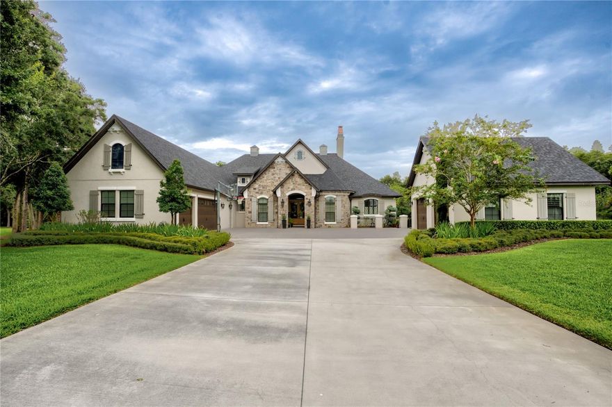 In the enchanting community of Magnolia Farms, a most prestigious gated community, stood a majestic, single-story abode constructed with the finest materials & an eye for detail. As you cross the threshold, you’re greeted by a grand entrance that whispers of royal gatherings & elegant soirées. The soaring ceilings & wood beam rafters draw your gaze upward, hinting at the magic that lies within. The formal living & dining rooms, each graced with a wall of French doors, invite the outdoors in, opening to an exquisite living area where dreams & reality merge. The gourmet kitchen is a culinary wonderland where any chef would feel at home. Imagine preparing feasts with your Thermador refrigerators, dual sinks, endless prep space, & a dedicated beverage station. The BTU boiler & gas stove stand ready to cook up delights, while convection ovens ensure perfection in every dish. A pantry large enough to lose yourself in, with built-in freezer drawers, offers storage aplenty. Quartz countertops sparkle under elegant cabinet lighting, casting a magical glow over your culinary adventures. Gather in the spacious breakfast nook every morning, where the sun's rays dance in the windows during family meals. Adjacent, the large family room beckons with its massive sliders, blending indoor & outdoor living. Whether lounging by the pool or enjoying a quiet moment on the private covered patio, you'll feel like royalty in your own realm. This home is as practical as it is beautiful, with two secondary bedrooms at the rear, connected by a Jack & Jill bathroom & a bonus room that opens directly to the pool for guests or extended family. The in-law suite is a sanctuary of its own, complete with a living room, kitchenette, bathroom, & direct pool access. At the front of the home, there are two more generous bedrooms, each boasting its own private baths, ensuring everyone has their own slice of paradise. The expansive master suite is a retreat within a retreat, offering his & her walk-in closets, a luxurious soaking tub, & direct access to the pool area. The outdoor space is an entertainer’s dream come true. Imagine hosting a tea party in the front courtyard or grilling up feasts in the brand-new outdoor kitchen by the pool. A stunning rock waterfall cascades into the pool, creating a serene backdrop for summer days. As night falls, gather around the fireplace or relax under the gazebo & watch the gas-powered fire bowls blaze in the night. Practical features abound in this fairy-tale home. A generator stands ready to power your dreams even when the power company cannot, while the built-in bug slayer mosquito system ensures nothing spoils your outdoor adventures. The outdoor audio system provides the perfect soundtrack, & gas fire bowls add a touch of drama to evening gatherings. The attic elevator makes storage a breeze, & the customizable exterior lighting sets the mood for every holiday or party. Stay fit in the air-conditioned gym in the fifth garage bay, while tech lovers marvel at the full network cabinet with a camera system & axis points. Every closet in the home has built-in systems, ensuring even your wardrobe lives in luxury. The garages offer an EZ storage slat system & overhead storage because even your chariots deserve a royal treatment. All of this splendor sits on an oversized lot adorned with fruit trees, offering a perfect blend of luxury, comfort, & paradise. Wait no longer and let your fairytale begin right here in this lap of luxury.