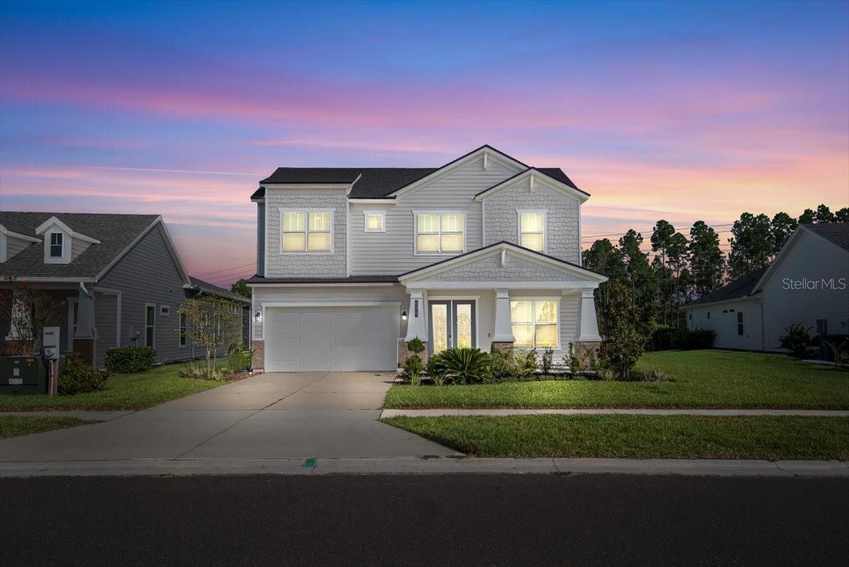 Skip the wait and dust of new construction! This better than new ICI built Santa Rosa floor plan offers designer finishes, tranquil water view and is ready TODAY! Just 2 years Young, this immaculate home blends function with upgraded features in one of St Johns County's most desirable gated communities! Enjoy open concept living with soaring ceilings, abundant natural light and a gourmet kitchen with a butler pantry that flows into a spacious living and dining area. The split bedroom plan has the primary bedroom suite downstairs and 3 bedrooms and loft upstairs. There is also a separate office space and a 3 car tandem garage. Step outside to a peaceful screened lanai that overlooks the water - no construction noise, no muddy lots, just serene views and move in perfection!