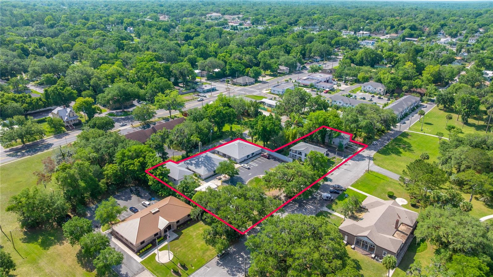 Rare opportunity! Being offered for the first time, take note of this once in a lifetime opportunity to own a multifamily property with frontage along Ocala's Tuscawilla Park. Featuring a grouping of 4 parcels, each with a residential component, the location and future opportunity speak for itself. Located in an area of focused redevelopment, there is limited opportunity to own private property alongside Tuscawilla Park. Close to public transportation and walkable to both midtown and downtown, restaurants and shopping. Your residents can walk through Tuscawilla Park, enjoy a show at the Reilly Arts Center or the numerous art galleries, play tennis at the city courts across the street, enjoy the playground, enjoy a meal at Midtown Station that is steps away - the opportunities are endless! All City of Ocala residents have a free membership at the award winning Mary Sue Rich Community Center. Buy this property and live in the main house while you rent out the rest or keep it all an income producing property. All units are individually metered and are on City of Ocala utilities for electric, water, sewer and trash. A detailed list of each property with size, age and updates is available. These contiguous properties are being sold as a package and have been well maintained by the original owner. Get in on a piece of history and future redevelopment now!
