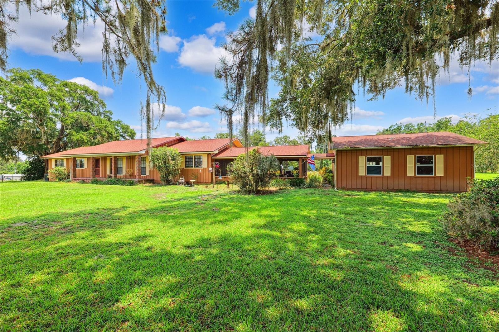 Sprawling Ranch Oasis with Pool on 5 Cleared Acres - Lake Lindsey Road, Brooksville, FL. Welcome to your own private slice of Florida paradise! Nestled on 5 fully cleared, usable acres in the peaceful countryside of Brooksville's desirable Lake Lindsey Drive, this charming ranch-style estate offers the perfect blend of comfort, space, and nature—all just minutes from town conveniences. A Home Designed for Easy Living & Entertaining Step inside and immediately feel at home in this warm, well-appointed residence featuring Hickory hardwood floors throughout and wood & French doors that open to outdoor living at its best. The spacious, light-filled layout includes a large family room, a formal dining room for gatherings, and a cozy wood-burning fireplace with a built-in indoor/outdoor wood storage compartment—no need to step outside on chilly nights. Love to entertain? You'll be drawn to the open eat-in kitchen with solid wood cabinetry and a brand-new refrigerator, flowing effortlessly into a pool table/sports room with a dedicated refrigerator for game-day snacks or drinks. Indoor Comfort Meets Outdoor Living. This home is designed to keep you cool and comfortable all summer long with a whole-house attic fan and a recently serviced A/C system with cleaned coils for efficiency. The septic system was just pumped and fitted with a new lid on 6/20/25, giving you added peace of mind. Outdoors, the fun continues with a solar-heated in-ground pool surrounded by a screened lanai—your private tropical retreat for year-round relaxation. A 25' x 17' brick-floored screened breezeway connects the garage to the main home, offering extra living and seating space perfect for casual dining or enjoying the Florida breeze. Beautiful Acreage with Room to Roam. The land itself is a dream: fenced and cross-fenced, ideal for animals, gardening, or simply enjoying the wide-open space. Fruit lovers will appreciate the mature pear and fig trees right on the property. The pole barn includes an indoor workshop, making it ideal for hobbyists, mechanics, or extra storage. A hurricane-rated garage door adds extra protection during storm season. Privacy & Practicality. Set back from the road on a private drive, this home offers unmatched privacy and a peaceful, rural setting while remaining close to shopping, dining, and recreation. Whether you're looking for a forever home, multi-generational space, or a serene retreat, this property has it all. Don't miss your opportunity to live the Florida Lifestyle You Deserve!