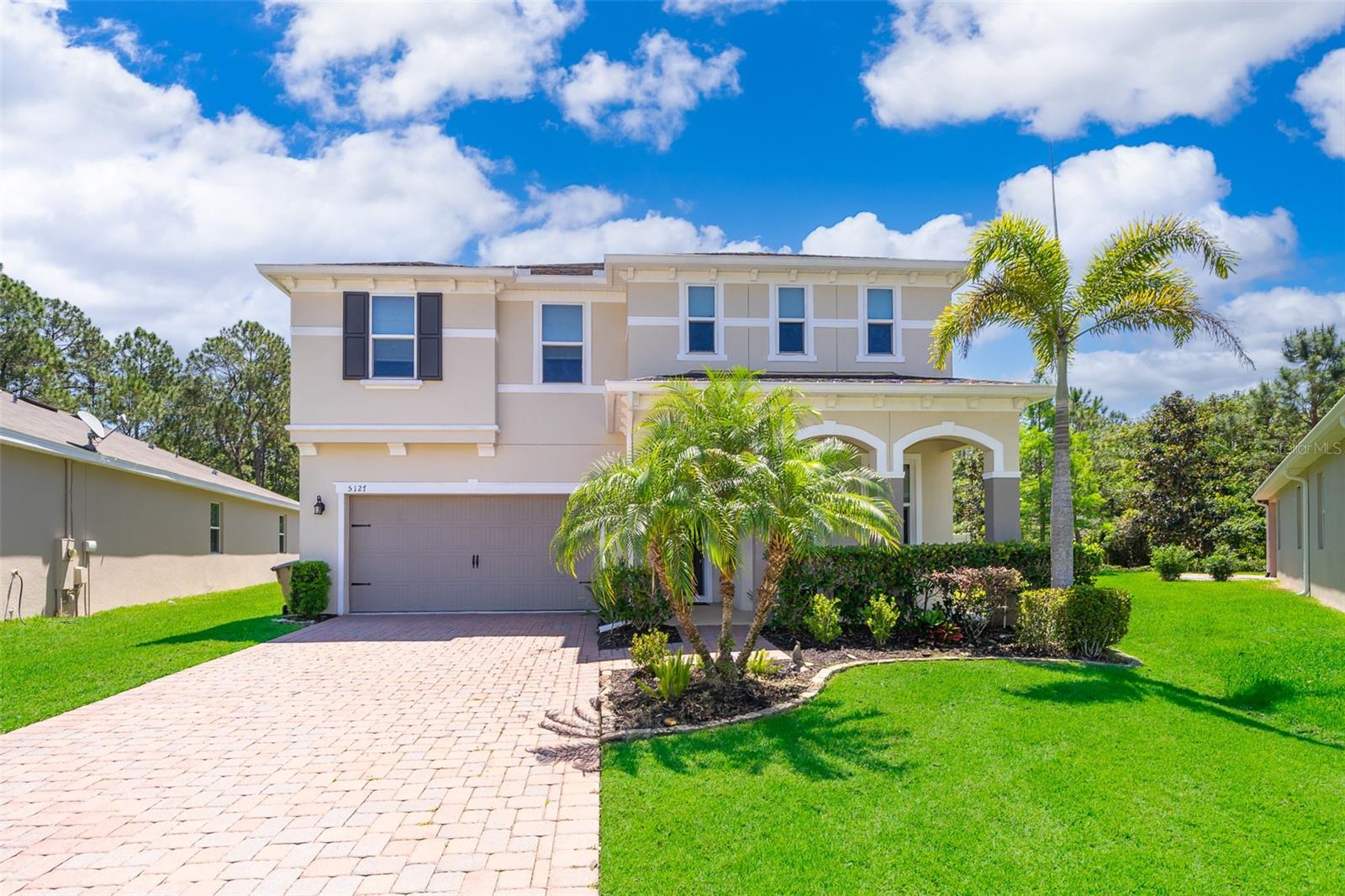 WOW! Look at this exquisite home! Less than 10 minutes from Medical City/Lake Nona area!! This incredible 5 bedroom, 3 bath home sits on an oversized lot with 1/3 acre. NEW COMPRESSOR, NEW FIXTURES THROUGHOUT! CUSTOM CLOSETS, NEW BACKSPLASH IN KITCHEN* Spacious backyard with NEW PATIO PAVERS is fully fenced and backs up to a conservation area. FLOOD ZONE X (property appraiser info is not accurate) NO REAR NEIGHBORS! 2 car attached garage with brick paver driveway. Lovely front porch area, perfect for enjoying the tranquility of the neighborhood in the early mornings! Upon entering the home, on your right is your den, office, reading room, etc. BEAUTIFUL VINYL PLANK FLOORING! Lots of natural light with all the Low E windows. Energy Star 5Home and the electric bill proves it. The kitchen has 36" upper cabinets with crown molding, recessed lighting, granite countertops, stainless steel appliances and upgraded kitchen sink and faucet. The heart of the home has an open floor plan with plenty of other rooms downstairs for guests to spread out. There is a guest room and full bathroom downstairs as well. Under the stairs is oversized storage space with lots of possibilities. Upstairs has an oversized loft, 3 more bedrooms, a full bathroom, oversized laundry room, several storage closets - plus the Master Bedroom/Master Bathroom. Oversized and very spacious Master Bedroom featuring tray ceilings and TWO walk-in master closets!! The master bathroom has granite countertops, dual sinks, linen closet, plus a private room for the commode. The garden tub and stand-up shower have upgraded tile. Master Bathroom windows have special tinting and no need for blinds - no one can see in so you can enjoy the full view of your backyard and the natural light any time of day. Home features 9'4" ceilings downstairs and 8' ceilings upstairs. Granite Countertops in every bathroom! It's in the perfect location for business professionals or a large family! Less than 10 minutes from Medical City/Lake Nona, 45 minutes from several beaches, 25 minutes from Orlando International Airport. Multiple Golf Courses to choose from. Great Schools nearby! Come see this home in person! You will fall in love!