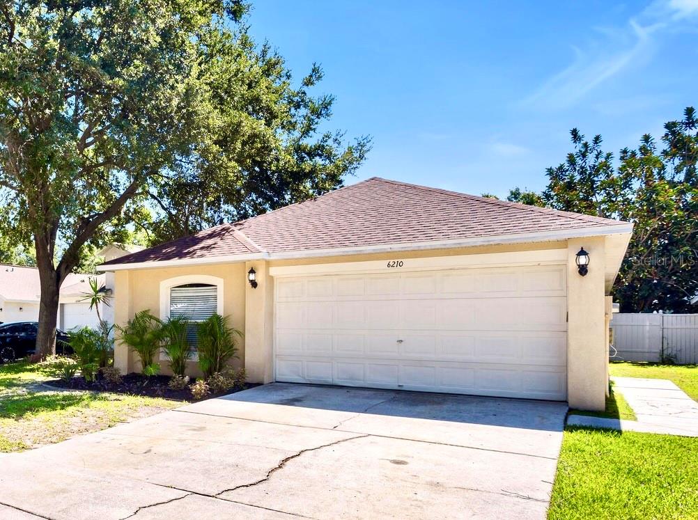 Welcome to Lake St Charles in Riverview! This exciting new listing features 3 bedrooms, 2 bathrooms, and 1,292 square feet with over $36,000 in thoughtful improvements, offering a turnkey opportunity for the next lucky homeowner. You will love the charm of this quiet tree lined street! Inside, you’re welcomed into a bright and open floor plan with soaring ceilings, arched architectural details, and updated laminate wood flooring installed throughout the main living areas. The spacious great room features plantation shutters, laminate floors and a convenient pass through window to the kitchen. The kitchen has been updated with granite countertops, a modern tile backsplash, and stainless steel appliances. There is plenty of eating space in the kitchen which also features a breakfast bar, drop pendant lighting, and sliding glass doors that lead to the lanai - bringing in plenty of natural sunlight. The split-bedroom layout includes three comfortable bedrooms with ample closet space. The primary suite features a custom walk-in closet system installed in 2020, and access to a private en-suite bath. Both bathrooms in the home were completely renovated in 2018 and now feature modern tile work, contemporary vanities, designer lighting, and sleek fixtures. Step outside to a fully fenced backyard with a concrete patio, perfect for outdoor dining, relaxing, or entertaining. Additional enhancements include a new HVAC condenser installed in 2019 and a roof replacement in 2021. Tucked away in a well-established neighborhood with low HOA fees, this home offers easy access to top-rated schools, shopping, dining, and major highways, making it a smart choice for first-time buyers, investors, or anyone looking for a well-maintained home in the heart of Riverview. Welcome Home!