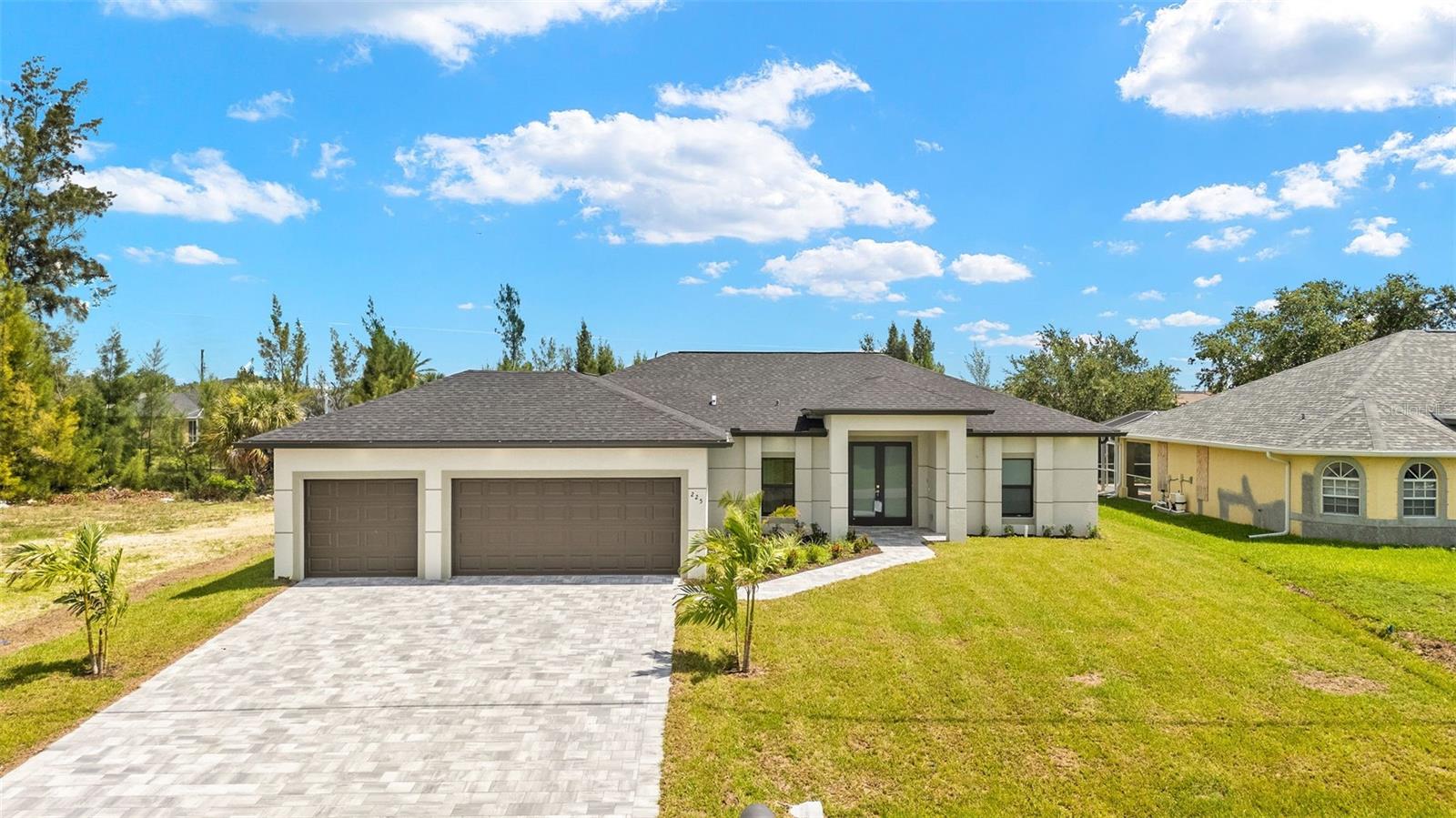 Brand new construction home with a pool! Located on 120 ft wide freshwater canal with access to lakes. Home is on city water, sewer, and irrigation. Step inside and be greeted by high ceilings, open-concept living, and designer finishes throughout. The heart of the home features a gourmet kitchen with granite countertops, large kitchen island, soft-close cabinetry, and stainless steel appliances—perfect for entertaining or relaxing evenings in. The living area includes sliding glass doors opening to the large lanai and panoramic views. The spacious primary suite offers large sliders opening directly to your private screened lanai and sparkling pool, as well as two walk in closets with built in shelving. The ensuite spa-like bathroom has dual sinks and a large walk in tiled shower with a glass door. Whether you're cooling off on a summer day or enjoying the golden hour overlooking the canal, this outdoor space is your personal paradise. Additional highlights include: paved driveway and lanai, hurricane impact windows and doors, 3 car garage, large lanai equipped with pool cage, inside laundry/utility room with cabinetry, beautiful tile throughout the home, plenty of closets all with built in shelving. For added safety, all doors leading to the pool area are equipped with alarm sensors. No HOA. Not in a flood zone. Centrally located just minutes from the Pine Island corridor which offers various shopping, dining, and more. There are many parks in the immediate plus nearby Gator Mikes, Sunsplash, and NW library. Cape Coral is well served by major roads US-41 and I-75 making traveling easy and convenient. Don’t miss this rare opportunity to own brand new construction with direct freshwater access in sunny Florida. Move-in ready and waiting for you!