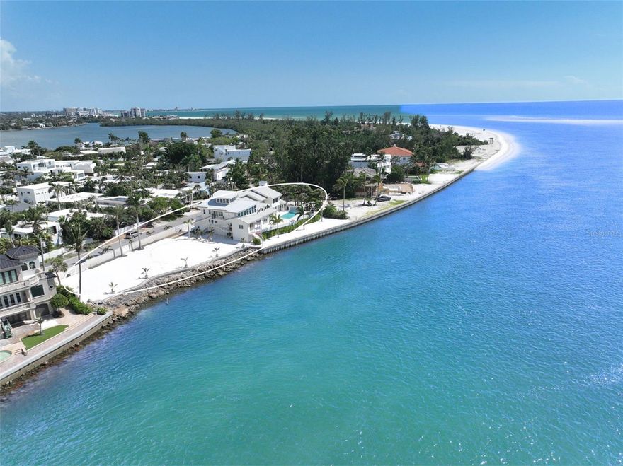 ONE OF THE LARGEST GULFFRONT ESTATES OFFERING 249’ OF STUNNING GULF VIEWS | LIDO SHORES | SARASOTA | Situated within the prestigious enclave of Lido Shores in Sarasota, this exceptional estate seamlessly marries architectural pedigree with unmatched natural beauty, offering the perfect balance of accessibility—just minutes from the vibrant St. Armands Circle and dynamic downtown Sarasota—all with complete seclusion and privacy. This is far more than a luxury residence; it represents a legacy property conceived by one of Southwest Florida’s most acclaimed architects, destined to endure as one of Lido Key’s most distinguished Gulf-front estates for generations to come.  Perched on the coveted Gulf of Mexico, this extraordinary estate represents the pinnacle of coastal luxury, designed by celebrated architect Clifford M. Scholz, founder of CMSA Scholz, Oswald & Shaffer whose vision transforms this super-sized pristine Gulf frontage estate into an architectural symphony of sophistication and modern elegance. This distinguished 6,862-square-foot residence commands stunning panoramic views of the Gulf, standing as one of Sarasota’s most coveted coastal properties where thoughtful scale and precise attention to detail converge in perfect harmony. The property is strategically elevated for optimal protection from storms (no water intrusion from storms). The interior unfolds as a masterclass in refined design, with soaring vaulted ceilings,  curated designer lighting, formal living and dining rooms framed by floor-to-ceiling glass with panoramic water views, generous gathering spaces, a sun-drenched breakfast nook, a versatile bonus flex room extends living possibilities just steps from the resort-style pool. At the heart of daily life lies a custom culinary masterpiece, anchored by an elegant La Cornue range and a matching commercial vent hood, a large butler’s kitchen, and a built-in bar for ease of prep and service for bespoke, large gatherings of family, friends or business associates.  The gourmet kitchen’s impressive arsenal includes a Sub-Zero refrigerator, Miele dishwasher, Bosch oven, Dacor microwave, and wine refrigeration. The residence’s five bedrooms, six full bathrooms, and two powder rooms provide luxurious accommodations for family and guests, including two distinctive guest suites featuring charming loft spaces. The serene primary suite serves as a private sanctuary, while two dedicated office spaces offer quiet retreats for productivity. The home’s wellness amenities include a traditional sauna and state-of-the-art infrared light therapy room, bringing spa-inspired luxury into daily life. Throughout the residence, sophisticated architectural details, including an elegant custom-crafted staircase and two inviting fireplaces, reinforce the home’s exceptional character and superior craftsmanship.  The outdoor living experience unfolds as a private resort oasis, where a stunning pool with cascading waterfall features becomes the centerpiece of the professionally designed landscaping that embraces and enhances the spectacular Gulf-front setting. The property’s distinguished presence is defined by Turkish white shell stone perimeter walls and elegant gates that provide both privacy and architectural gravitas. Generous grounds offer exceptional potential for expansion or additional structures, this remarkable property presents the rare opportunity to create a truly private family compound.