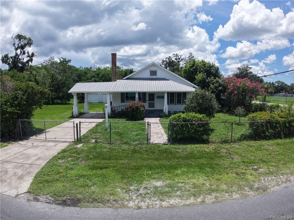 Step into a piece of Dunnellon history! Originally built in 1943, the Dinkins Family Homestead is a rare find, beautifully blending vintage charm with modern updates. Located on a generous 0.82-acre fenced corner lot in the historic district of downtown, this unique property offers exceptional flexibility with Residential/Office zoning in a mixed-use neighborhood. For the past decade, this home has served as a successful office, but it’s equally suited for someone seeking a one-of-a-kind residence with character and visibility. Whether you're a business owner relocating to this thriving area or a buyer looking for a high-profile historic home, this property delivers. 3 Bedrooms | 2 Full Bathrooms, Detached Garage + Attached Carport | Fenced | Plenty of Parking Key Features: Upgraded 200-amp electric panel and modern plumbing, Connected to city water and sewer, Newer HVAC system, durable metal roof, Original clawfoot tub, enameled kitchen sink, cabinets, leaded glass windows, Spacious living/dining room (ideal as a lobby) with built-ins and original wood-burning fireplace. Front and back porches are perfect for rocking chairs and relaxing evenings, Convenient location near Rainbow Springs, the Withlacoochee River, shopping, dining, and all major roadways. With a versatile layout and unbeatable location, the possibilities here are endless—whether you're envisioning a home, office, studio, gallery, or combination of uses. Owner financing is a possibility with a substantial down payment. Don’t miss this rare opportunity to own a piece of Old Florida in the growing, opportunity-rich community of Dunnellon.