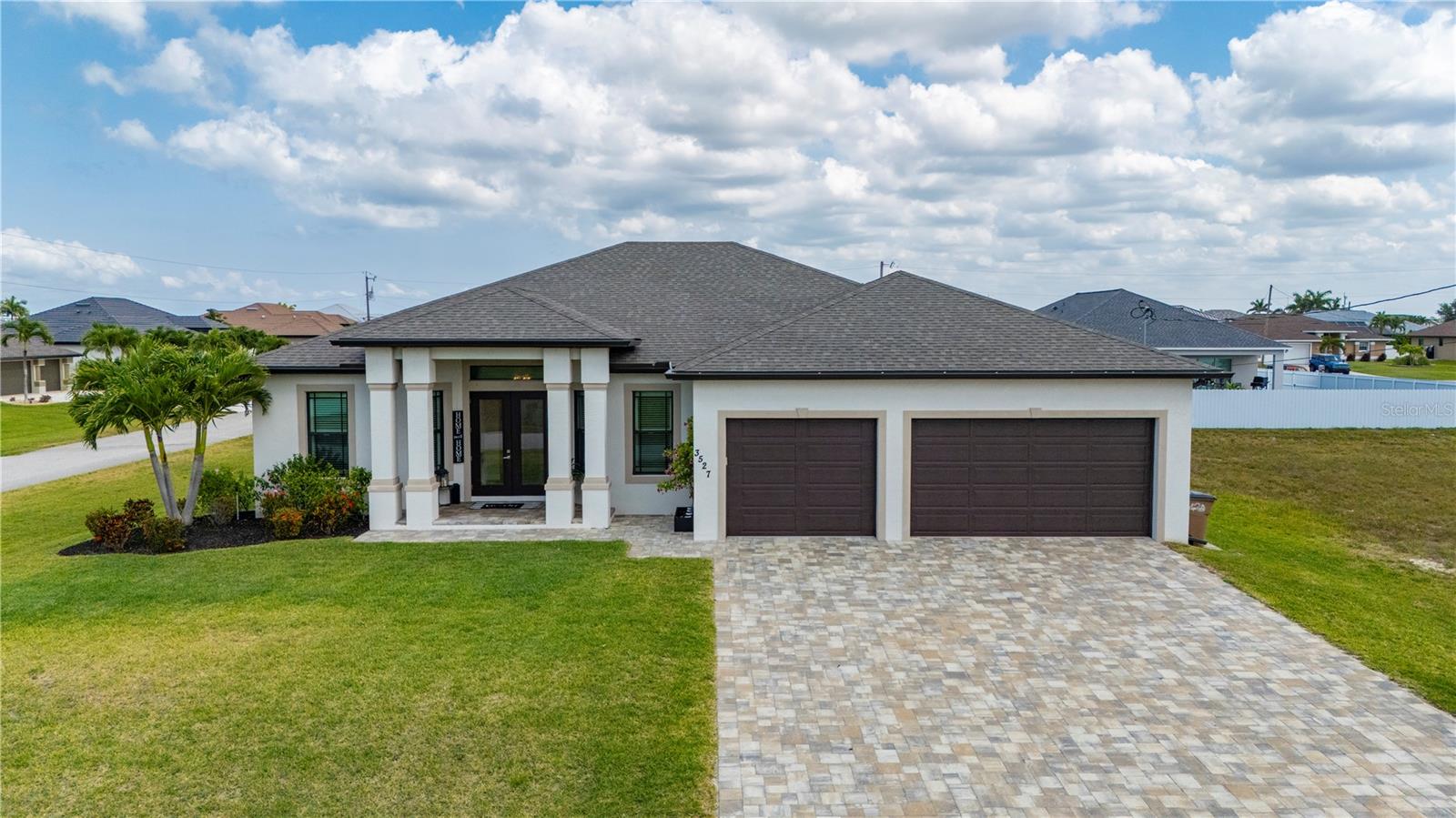 Had appraisal done , Huge $30,000 price reduction . This absolutely stunning 2021 custom-built home offers the perfect blend of luxury, comfort, and thoughtful design. Featuring 5 spacious bedrooms, a dedicated office, 3 full bathrooms, and 2 luxurious primary suites—all situated on a beautifully landscaped double lot with a 3-car garage—this home has room for everyone. As you arrive, a paved driveway leads to elegant double doors, setting the tone for the craftsmanship found throughout. Inside, you’ll find soaring ceilings, 8-foot interior doors, 6-inch baseboards, crown molding, plantation shutters, and 24x24 ceramic tile flowing seamlessly throughout the home. The large living room is ideal for entertaining, with an oversized ceiling fan, and a full wall of impact-rated pocket sliders that open to the screened lanai and pool area.
The open-concept kitchen is a chef’s dream, overlooking both the living room and pool. It features a dramatic 14-foot granite waterfall island with built-in, push-to-open hidden USB outlets, custom soft-close cabinetry that extends to the ceiling, pull-out drawers, and a spacious built-in pantry. All kitchen appliances are still under warranty, offering peace of mind. Both primary bedrooms are retreats in their own right—each with large walk-in closets, private sliders leading to the pool, and spa-inspired en suite bathrooms. The main primary bath boasts a 10-foot walk-around shower with a custom glass backsplash and premium granite finishes. All three bathrooms include walk-in showers with matching granite for a cohesive, elegant look.
Step outside to your private oasis: a spacious 1900 sqft screened-in lanai with beautiful pavers, a custom outdoor kitchen, and plenty of space for lounging or entertaining. The heated saltwater pool features integrated lighting and extra deck space for patio furniture or sunbathing. This home is built to last with impact-resistant windows and doors, a monolithic tie beam for added structural integrity, a whole-house reverse osmosis system, irrigation, and an HVAC system from 2021 that’s been professionally serviced every 6 months.
Every detail of this property was designed with quality, durability, and luxury in mind. June 19th, 2025 all tiles floors have been professionally regrouted and sealed. This is not just a home—it's a lifestyle.