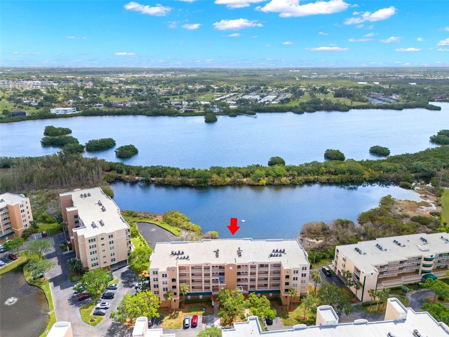 Available for annual lease, welcome to 6475 Shoreline Drive #5403 in St. Petersburg, FL—an exceptional top-floor waterfront condo located in the highly sought-after 24-hour guard-gated community of Shores of Long Bayou. This spacious 2-bedroom, plus den, 2-bath residence with inside utility room that offers the privacy of no neighbors above, peaceful panoramic water views, and the rare convenience of a private oversized one-car garage along with a dedicated storage room that is located just outside the unit, perfect for beach gear and bikes. The open-concept layout is filled with natural light and features a well-appointed kitchen with granite countertops with white cabinetry, a pantry, and a bright eat-in nook, while the breakfast bar flows seamlessly into the expansive living and dining areas. A 22-foot screened waterfront balcony, accessible from both the living area and the primary suite, provides a serene outdoor retreat overlooking the bayou and mangroves. The primary suite includes dual walk-in closets and a spacious en-suite bath with double vanities and a step-in shower. Two additional bedroom offers flexibility for guests, and the den makes a great home office, or additional living space, complemented by a full-size laundry room and ample storage throughout. Rent includes cable, internet, water, sewer, and trash and 24-hour security, providing a low-maintenance lifestyle. Residents of Shores of Long Bayou enjoy resort-style amenities including beautiful pool, clubhouse, scenic lakes, and a 1.7-mile walking and biking trail. Conveniently located near Madeira Beach, Redington Shores, Seminole Lake Park, the Pinellas Trail, Seminole City Center, Bay Pines, local marinas, golf courses, and downtown St. Petersburg. Sorry not pets or smokers are allowed. Could come furnished or unfurnished.