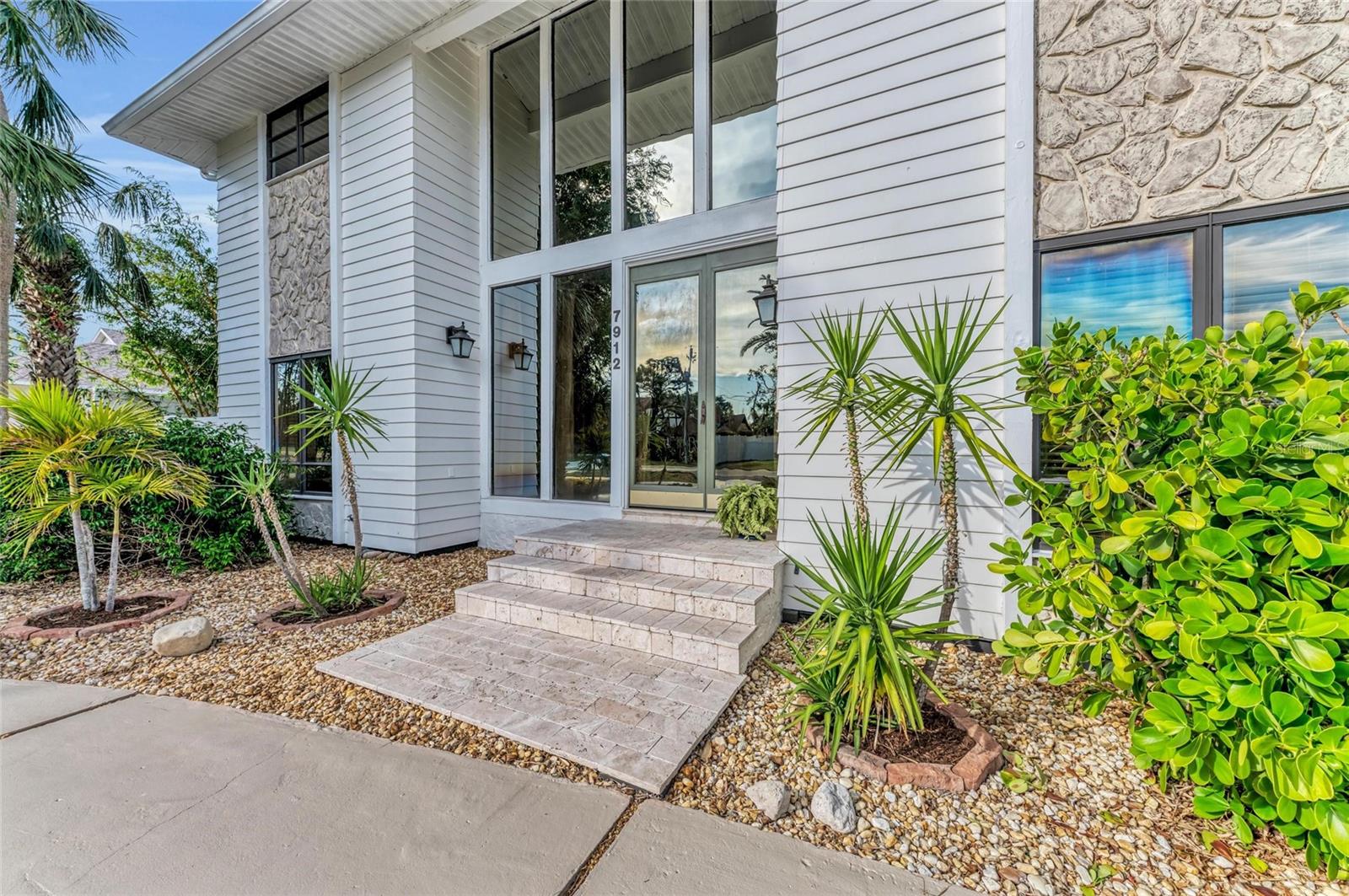 One or more photo(s) has been virtually staged. A Rare Opportunity in 34209 — Custom Show Home with Unmatched Style and Views
Originally built in 1977 as a showcase home, this exceptional, one-of-a-kind custom residence is nestled on a spacious corner lot in the highly sought-after 34209 zip code. It offers a seamless blend of sophisticated elegance and casual comfort in a prime location.
Distinctive Design & Light-Filled Spaces
From the moment you enter, you're welcomed by a soaring 20-foot cedar ceiling that opens to a beautifully flowing layout including the living room, library, and kitchen. The grand first floor features stunning imported travertine flooring, abundant natural light, and soaring ceilings that create a spacious, airy ambiance throughout.
Indoor Comfort Meets Outdoor Serenity
French doors throughout the home lead to an expansive lanai—perfect for entertaining or unwinding in privacy. Enjoy the inviting pool, wood deck, LED lighting, and a convenient half bath. The fenced yard offers privacy while showcasing Florida’s natural beauty with low-maintenance landscaping, including jasmine and gardenias.
Gourmet Kitchen & Living Areas Built for Connection
The spacious kitchen is a chef’s dream with a large center island, granite countertops, walk-in pantry, two GE dishwashers, a 36” gas cooktop, oven, and two sinks. The Family Room, adjacent to the kitchen, offers access to a full bath and pool deck—ideal for relaxed living or entertaining. The Dining Room comfortably seats 12 and boasts picturesque pool views, while the Living Room offers a private retreat with lush bamboo yard views.
Flexible Spaces for Every Lifestyle
Whether you’re working from home, homeschooling, entertaining, or seeking a peaceful escape, this home adapts to your lifestyle. The Library/Office features built-in shelving, French doors, and its own exterior entrance, making it perfect for remote work or a serene reading nook. A versatile Bonus Room, currently used as a music room, could serve as a playroom, sitting area, or creative studio.
Five Spacious Bedrooms + Private Retreats
Upstairs, all five bedrooms are generously sized with new carpet (2024) and walk-in closets. Three of the bedrooms open to the expansive upper deck offering breathtaking views of the Manatee River, Sunshine Skyway Bridge, and even Cape Canaveral rocket launches. The Master Suite features two walk-in closets and sliding doors to enjoy peaceful sunrises. Another Bonus Room with pine paneling and vaulted ceilings opens to a private balcony with river views—perfect as a guest suite, recreation room, or studio, complete with a full bath and large closet.
Exceptional Location & Outdoor Lifestyle
Located near some of the area's finest nature spots—Desoto National Memorial, Riverview Pointe Preserve, Robinsons Preserve, Palma Sola Botanical Gardens, and Shaws Pointe Park—all within 2.6 miles. This is Florida living at its best: tranquil, spacious, and close to everything.