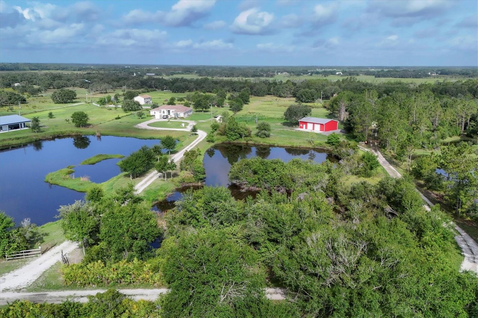No HOA restrictions! Check out these 10 buildable, secluded, and partially cleared acres with breathtaking views and two ponds, perfect for building a home, farming, fishing, HORSES! and more. With all utilities including high speed internet you could park you RV on the land while building the home of your dreams! The property includes an existing 1,500sf metal 4 car garage / warehouse with two 10' bay doors perfect for boats, trailers, farm equipment, you name it. 400sf of the warehouse was recently converted to air conditioned office/flex space with a full bathroom. It has electric, water, high speed internet, and connected to septic. Fully insulated on all 4 sides (including the ceiling) and has full size washer & dryer hookups. There's still plenty of storage above the office space in the warehouse. Remaining warehouse / workshop space approximately 1100sf+/-. High and dry, flood insurance not required, although some parts in the back do stay wet during heavy rains in the summer. The pastures are perfect for a mini farm and are fenced & cross fenced, with the last pasture by the creek remaining unfenced. There's an area in the back with beautiful oak trees that would make the perfect secluded homesite. Per the previous owner one of the two custom ponds is dug to 32' for good drainage and to keep the water cool for healthy fish while providing a place for storm season run off. This larger front pond is spring fed and stocked with bass and blue gill. The other smaller pond is a livestock pond. Wild birds visit daily including bluebirds during their annual migration, as well as wild turkeys, deer, and monarch butterflies. Duette Nature Preserve and riding trails is less than 1 mile from the property and can be directly accessed via Logue Rd. At over 21,000 acres, the Duette Nature Preserve is the largest preserve in Manatee County with a wide variety of game, non-game animals, and native plant communities. It contains the headwaters of Manatee River. 3045 Logue Rd is a terrific piece of property located away from city life but close enough to Lakewood Ranch and Sarasota's excellent shopping, restaurants, golf courses, and entertainment. Request your private showing of this 10 acre piece of paradise today! Subsurface rights included. Also available for LEASE @$3,000/mo