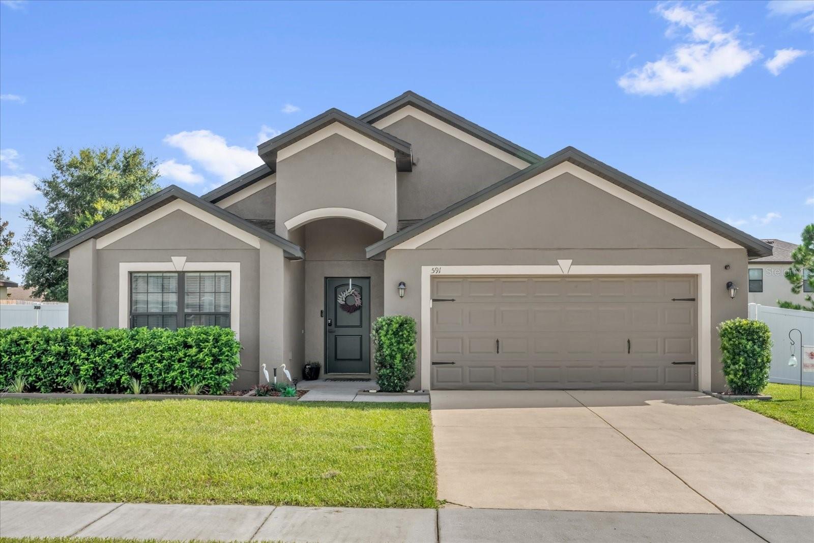 This stunningly renovated 4-bedroom, 2-bathroom, 2-car garage home sits on an oversized lot in the highly sought-after Groves at Baytree community in Tavares — where nature, privacy, and location come together seamlessly. Surrounded by lush conservation areas, scenic parks, and sparkling lakes, this home offers the best of both worlds: a peaceful neighborhood setting just minutes from shopping, dining, and the vibrant, waterfront downtown Tavares, famously known as “America’s Seaplane City.” Inside, you’ll be impressed by the open-concept layout and abundance of natural light flowing through oversized windows. The completely updated modern kitchen features gorgeous stone countertops, brand-new stainless steel appliances, a deep stainless steel sink with LED faucet, and clean, contemporary finishes throughout. The spacious primary suite offers a large walk-in closet and a beautifully updated ensuite bathroom with dual vanities, stylish vessel sinks, new lighting and tile flooring, and a new toilet. All four bedrooms are generously sized and feature premium laminate wood flooring for a cohesive, elegant feel. Step through the double sliding glass doors to your private covered lanai, perfect for morning coffee or outdoor dining. The fully fenced backyard provides the ideal space for pets, play, or entertaining — complete with mature shade trees for added comfort and privacy. Residents enjoy access to a community clubhouse with a fitness center, weight room, and outdoor pool, making it easy to maintain an active and social lifestyle. This move-in-ready home offers the perfect blend of style, space, and location — schedule your private showing today before it's gone!