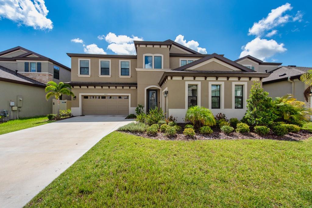 ***ASSUMABLE 5% INTEREST RATE***Where modern luxury meets the beauty of nature — this stunning 2-story Hawkstone home was built in 2023 and offers nearly 4,300 sq ft of thoughtful design and effortless elegance. Tucked along a peaceful conservation backdrop, the home feels like a private retreat while still being part of one of Lithia’s most vibrant communities. Inside, the soaring, light-filled foyer creates an immediate sense of space. French doors open to a quiet den for working or reading, while a flexible bonus room gives you room to dream — whether it’s a home gym, hobby space, or media lounge. The kitchen is a showpiece, with a massive quartz island at its center, extended cabinetry, a gas cooktop, and a walk-in pantry that’s as practical as it is generous. Subtle touches like pendant lighting, smart thermostats, and modern fixtures make the space feel elevated yet comfortable. Large sliding glass doors connect the heart of the home to an oversized lanai, perfect for coffee at sunrise or dinner with friends as the day winds down. A private guest suite on the main floor offers its own full bath and walk-in closet — ideal for visitors or multi-generational living. Upstairs, the primary suite feels like a personal hideaway, complete with a spa-style bath, an enormous walk-in closet, and a balcony that’s tailor-made for quiet moments and sweeping views. The upper level also features a bright loft and secondary bedrooms with a Jack-and-Jill bath, giving everyone their own comfortable space. Living in Hawkstone means resort-style pools, community parks, and endless trails right at your doorstep. Triple Creek Nature Preserve and Triple Creek BMX add even more opportunities to explore, play, and stay active. This is more than a house — it’s the kind of place where life feels both connected and wonderfully your own.