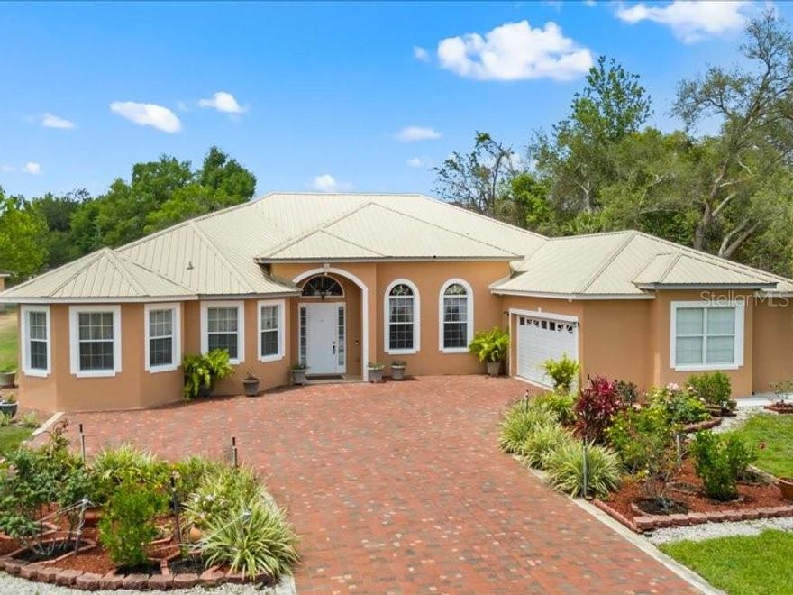 Welcome to 2002 Adair Street – a beautifully maintained estate nestled in the heart of Ocoee, FL, on a sprawling 1.6-acre agriculturally zoned property.

This move-in-ready residence features 5 spacious bedrooms and 4 full bathrooms across 3,687 square feet of thoughtfully designed living space. The custom floor plan includes a luxurious primary suite with a spa-like ensuite bathroom, complete with dual vanities, a soaking tub, walk-in shower, and multiple closets for ample storage.

The kitchen offers generous cabinetry and countertop space, ideal for both everyday living and entertaining. Formal living and dining areas provide a perfect setting for hosting guests. With five versatile bedrooms, there’s plenty of room to create guest accommodations, a home office, gym, or personal library.

In addition to the main living area, an enclosed 600-square-foot space offers incredible flexibility. Outfitted with a gas range, sink, cabinetry, and its own cooling unit, this area—featuring two separate entrances from the exterior and two from the main house—can serve as a perfect venue for gatherings or be converted into a mother-in-law suite.

Truly move-in-ready with recent upgrades including a new metal roof and two 5-ton AC units (2023), full repaint, air duct cleaning, and insulation updates (2022), plus a new 3HP well pump and replacement of the water heater elements (2021).

Outdoor living is just as impressive. A large concrete slab hosts a 24x26 covered enclosure and porch, complete with water and electrical connections—ideal for entertaining. The backyard is home to a variety of fruit trees and a 20x12 shed, perfect for storing tools and lawn equipment.

Security and peace of mind are built in with a full chain-link fence around the perimeter and a comprehensive surveillance camera system.

Ideally located between world-famous beaches and top Orlando attractions, this home is just minutes from the 429, Turnpike, and 408, offering easy access to Orlando International Airport, healthcare facilities, and the scenic West Orange Trail. It’s also near top-rated schools and just one minute from Vignetti Park.

Don’t miss your opportunity to own a private retreat with all the conveniences of city living. Schedule your private tour today!

Please note: Preapproval or proof of funds is requested prior to scheduling a showing.