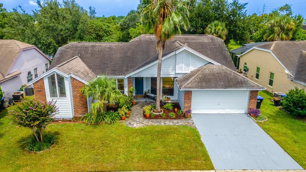One or more photo(s) has been virtually staged. Welcome to 2213 Oldfield Drive., a beautifully updated 3–4 bedroom, 2-bathroom home in the heart of Orlando’s Deerfield community. With over 2,190 square feet of thoughtfully designed living space, this stunning residence offers the perfect balance of style, space, and tranquility—all just 18 minutes from major Airports, highways, and major attractions! Step inside to discover a bright, open floor plan brimming with natural light. The formal living area provides a welcoming space that can serve as a sitting room, dining room, or additional entertaining area. Its location at the front of the home offers separation from the main living areas, making it a versatile option for a variety of uses. The remodeled kitchen features white quartz countertops, spacious center island, updated cabinetry, and modern lighting, offering a functional layout with space for cooking, casual dining, and gathering.Designed for both comfort and privacy, this home features a split-bedroom layout with three spacious bedrooms. The primary suite offers a quiet retreat with two walk-in closets, dual sinks, updated fixtures, and ample counter space, designed for everyday functionality and comfort. The secondary bedrooms are located off the great room and kitchen. The bathroom has been updated with white quartz countertops and contemporary finishes, adding style and function to daily living.The fully enclosed Florida Sunroom offers flexible use as a fourth bedroom, home office, or additional living space. Accessible from both the great room and primary suite, it overlooks the backyard and tranquil pond, framed by mature Bald Cypress trees. The water view provides a scenic backdrop visible throughout the day—with amazing sunsets! Recent UPGRADES include Roof, AC, two updated bathrooms with contemporary finishes, newer flooring, fresh, neutral paint and modern fixtures throughout, Well-maintained landscaping and curb appeal. Conveniently located near major highways, Orlando International Airport, and world-renowned attractions, this home also offers easy access to shopping, dining, and everyday amenities. Schedule your private showing today to experience the comfort, space, and location of this property.