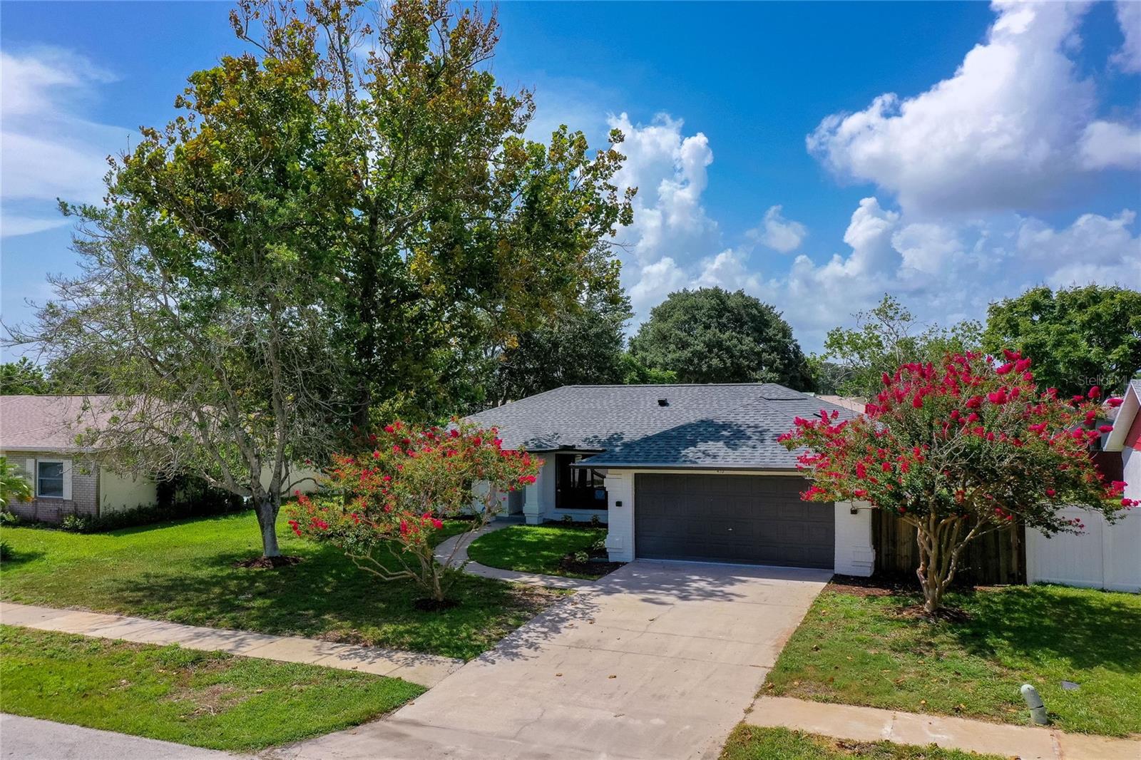 One or more photo(s) has been virtually staged. This beautifully renovated 3-bedroom, 2-bathroom home in Pelican Cove blends comfort, function, and style in a spacious, light-filled layout. Fully remodeled in 2025, the residence features an open floor plan with luxury vinyl flooring, recessed lighting, and twin skylights that invite natural light into the central living area. The heart of the home is the expansive kitchen, designed for both everyday living and entertaining. It boasts a massive L-shaped island with breakfast bar seating, quartz countertops, new stainless-steel appliances, and generous cabinet space - all seamlessly connected to the dining and living areas. The sunroom is bathed in natural light and provides the perfect space to relax or entertain. The split-bedroom layout offers privacy, with a generous primary suite that includes a dual-sink quartz vanity, walk-in closet, and a spa-inspired shower framed in marble-style tile. Two additional, well-sized bedrooms, each with ceiling fans, ample closet space, and natural light offer flexibility for family, guests, or a home office. Step outside to enjoy Florida living on the large rear patio, surrounded by mature trees - ideal for relaxing or family gatherings. The oversized two-car garage includes a laundry area, utility sink, and workbench. This completely renovated, move-in ready home with a brand-new roof offers peace of mind with no HOA restrictions, allowing extra flexibility for RVs or boats. Edgewater is home to over 150 acres of city parks, providing endless recreational options for everyone and you're just minutes away from local dining, shopping and entertainment. All information recorded in the MLS is intended to be accurate but cannot be guaranteed.