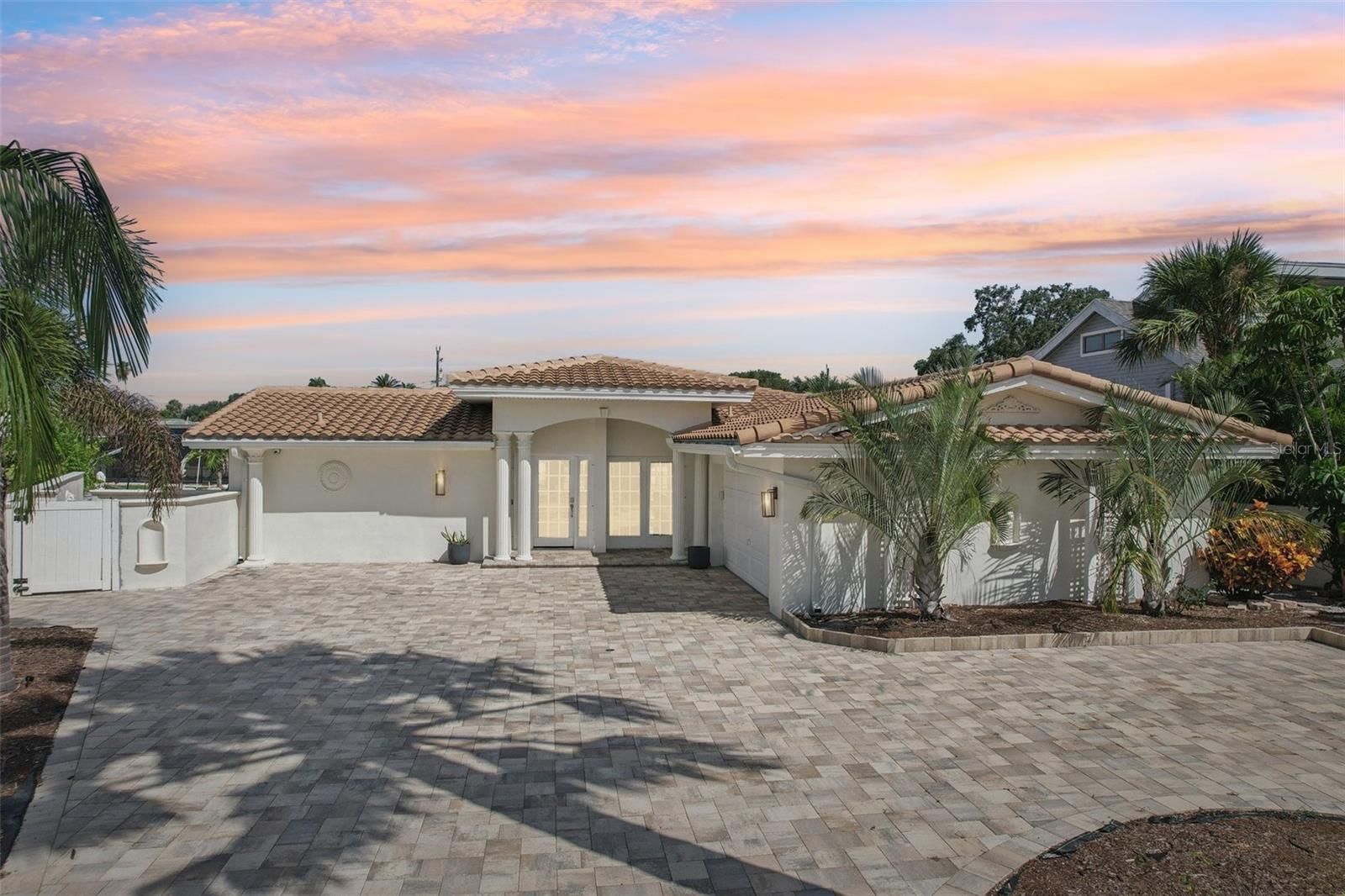 A Rare Waterfront Gem with Massive Income Potential in Largo’s Harbor Hills! This isn’t just a home—it’s a powerhouse investment opportunity wrapped in the beauty of Florida coastal living. Nestled at the end of a quiet cul-de-sac in the coveted Harbor Hills neighborhood, this spectacular 4-bedroom, 3-bath waterfront residence spans 2,378 square feet and offers jaw-dropping open water views, direct Gulf access, and an enviable 102 feet of water frontage. Currently operating as a high-performing, fully booked Airbnb, this property is already city-approved and inspected for short-term rental use by the City of Largo. With multiple six-figure gross income potential, this is a rare opportunity to own a turnkey income-generating machine, vacation retreat, or dreamy full-time residence—all in one and a business that works while you sleep. Inside, you'll find soaring elegance with luxurious travertine flooring, granite countertops, and spa-style ensuite bathrooms. The open-concept kitchen features a wide expanse of counters, solid wood cabinetry, sleek appliances, and abundant storage—perfect for entertaining or hosting guests. The dining area’s electric fireplace adds a cozy, refined touch to evening meals and gatherings. The primary suite offers a true retreat with glass sliders opening to the pool deck, a generous walk-in closet, and a private ensuite bath. Guests will enjoy their own beautifully appointed bedrooms and bathrooms, each offering privacy and comfort ideal for vacation rentals or extended stays. Step outside; whether you're soaking in the sun or entertaining guests, the private heated pool and expansive patio deliver a resort-style experience. Enjoy serene water views, multiple seating areas, and the perfect backdrop for unforgettable Florida sunsets. Boaters will love the 10,000 lb boat lift and direct Gulf access, putting adventure right at your back door. This home blends luxury and durability with a 50-year barrel tile roof, hurricane-rated windows, dual-zone HVAC, a tankless water heater, and a new paver circular driveway added in 2023. Everything has been thoughtfully maintained and updated to ensure ease of ownership and peace of mind for years to come. With no HOA and no CDD, this home gives you total freedom to enjoy, rent, or live on your terms. Minutes from world-class beaches, fine dining, and shopping, this Harbor Hills stunner combines luxury, location, and limitless potential. Whether you’re looking to build a portfolio, enjoy seasonal escapes, or settle in paradise full-time—this property delivers on every front. Call now and schedule your viewing today!