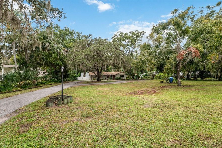 Priced competitively! Sellers have to relocate for work. This beautiful lakefront property sits on over an acre of land and offers peaceful views with your very own private dock with a sink and water hook up—ideal for enjoying sunsets, fishing, or hosting gatherings by the lake.
This property is complemented by a huge detached garage, half of the garage has recently been converted into a guest suite to make for an extra 5th bedroom and 3rd bathroom, walk in shower, brand new LVP flooring installed, offering excellent potential for rental income, guest accommodations, or an in-law setup to include a new mini-split A/C unit, garage electrical and plumbing ready to go- with materials left behind to help complete the project.
Inside the main 4 bed, 2 bath, move in ready home- there are two spacious great rooms/living rooms, one with an electric fireplace, the other used as a living room/dining room combo. The large kitchen has plenty counter space with a breakfast bar and gas stove. One of the bedrooms is super-sized with a private entrance and separate from the other three bedrooms. Large indoor laundry room has built in storage and private entrance.
Additional outdoor features include a concrete patio with an outdoor kitchen/grill/sink, plus electrical hookup for a jacuzzi, plus RV hookup, private fence with gate on both sides and chain link fence along the back with a gate leading out to the dock. Swing set, paddle boat and table by the dock included! In the front of the home there is plenty of parking space in addition to the wrap around paved driveway. 2 wells on property, main well tank replaced 2025. Water Softener included. Septic was pumped 1 year ago.   No HOA and No Flood Insurance Required, home is flood zone X, zone AE is toward lake side of property.