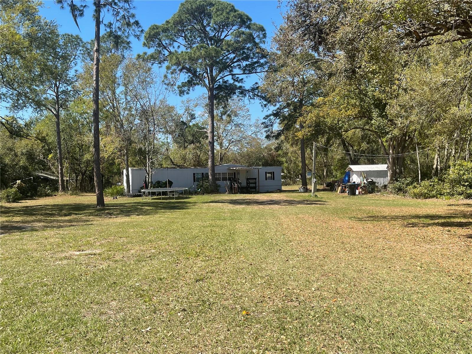 FL living at an affordable price or great investment property! This 2BD/1BA home is situated on1.06 acres. Short distance to all shopping, schools, medical facilities, and restaurants. Make this your new winter retreat or year around home. Call today, don't miss this great investment opportunity.