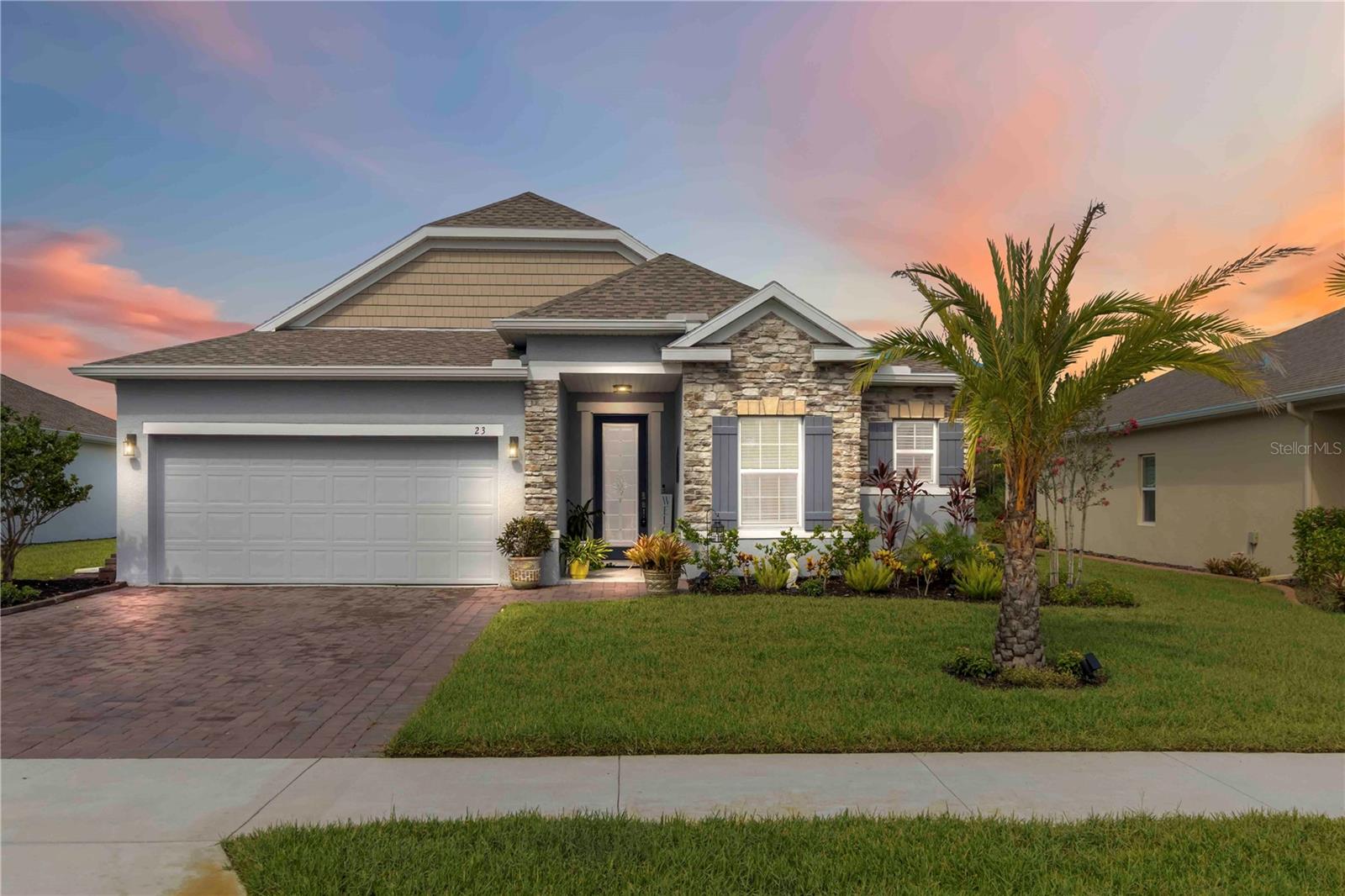 Welcome to this impeccable 3-bedroom, 2.5-bath home in the sought-after Hunters Ridge community. Built in 2023, this 1,853-square-foot home blends thoughtful design with stylish upgrades throughout. The open layout is anchored by beautiful tile flooring in the main living areas, with ceramic tile in the front entry and lanai for a clean, polished look. The kitchen is a standout, featuring stainless steel appliances, a large center island with a breakfast bar and built-in shelving, a dry bar perfect for your morning coffee setup, and a sleek tile backsplash. Two sliding glass doors in the living room let in plenty of natural light and open to a large screened-in lanai overlooking a peaceful pond—ideal for relaxing or entertaining. The primary suite offers a retreat-like feel with tray ceilings, a custom built-in closet system, and an en suite bath with dual sinks and a spacious walk-in glass shower. Additional upgrades include automated blinds on both triple-pane patio sliders. Enjoy maintenance-free living—your HOA fee includes internet, cable, and access to all the great community amenities: two clubhouses, three pools, a fitness center, tennis court, and playground. Conveniently located near Ormond Beach, shopping, dining, and local medical facilities, this home combines comfort, style, and convenience in one of the area's most desirable neighborhoods. Don’t miss the opportunity to experience Florida living at its best.