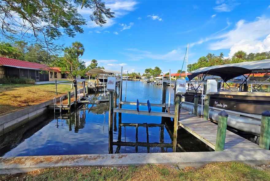 Most affordable WATERFRONT with deeded private dock and 10,000 lb lift! Seller is open to AN INTEREST RATE BUY DOWN scenario.  This charming canal front gem is the best that Florida Lifestyle has available, perfect for boating enthusiasts! Enjoy manatees swimming off your back patio. This is a lovely 2 bed 2 bath condo on a deep 4 foot salt water canal with remote controlled 10,000 lb lift and PRIVATE dock right out your back door. Brand new kitchen and appliances, new tile floors, and more! Large shady oak trees. Corner unit allowing lots of natural light. A covered carport. Enter laminate foyer which opens into a large living/dining combo pass through window in eat-in kitchen makes the space perfect for entertaining! Large master bedroom with plenty of closet space and a private bathroom with walk-in shower. Tile throughout the unit. Condo association just put a new roof on the unit. This is a very friendly and active condo development in the fishing village of Cortez. This gated community's facilities include mature landscaping, two heated saltwater pools, club house, sauna, tennis courts, park with gazebo and pier overlooking the bay, putting green, library, workshop with power tools and small fitness center in club house. Beautiful views down the canals or along Palma Sola Bay with fabulous fishing. The property also has an onsite resident property manager. Very pet friendly, community 2 dogs allowed no weight limit. Rentals are allowed with few restrictions.  The development is conveniently located near gulf beaches, major supermarkets and shopping centers including Publix and Walmart, the world-renowned IMG sports complex, as well as several other shops and restaurants. Nearby golf courses include: Manatee County, Timber Creek, Pinebrook Ironwood. Has been a wonderful income generating property for the current owner.  Unit has been unaffected in the last 3 hurricanes! Florida is not making any more waterfronts so make sure to get your piece today. Call to schedule a viewing today! Seller motivated... bring offers!
