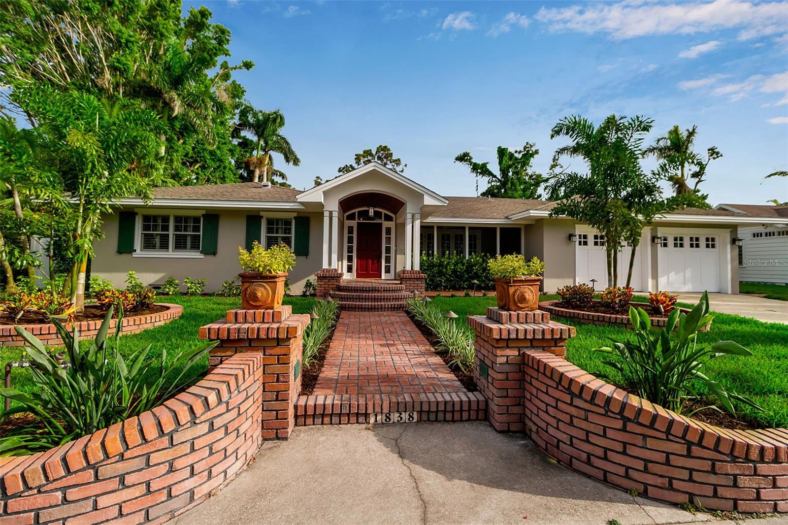 Ensconced in the heart of the highly esteemed West-of-Trail Avondale neighborhood, this stunning 5-bedroom, 4.5-bath, 4400 square foot residence seamlessly blends timeless charm with modern luxury. Situated on a rare 14,750 sq ft oversized lot, the original 1952 home was extensively renovated and thoughtfully expanded in 2022, more than doubling its original square footage—all on a single level. Step inside to discover an open-concept layout designed for both comfort and entertaining, featuring a state-of-the-art kitchen with custom cabinetry, high-end appliances, a spacious eating area, and an impressive full butler’s pantry. The kitchen flows effortlessly into the elegant dining room and the great room, all bathed in natural light and finished with premium materials throughout. The home offers a separate formal living room and a versatile bonus room overlooking the pool—ideal for a home office, library, or sunlit sitting room. The owner's suite features sliding glass doors to access the pool, transom windows that filter in natural light, two walk-in closets, and top of the line finishes in the spa-like bath. The guest wing offers an over-sized bedroom, perfect for a home gym or private in-law suite, and provides privacy and flexibility for guests or multigenerational living. Every detail has been meticulously curated, from designer finishes to thoughtful storage solutions. Outside, enjoy lush landscaping, generous green space, and the perfect setting for outdoor entertaining. The lap pool and spa offer privacy and access to indoor-outdoor living spaces. All of this is located in the highly sought after Southside Elementary School district, and within walking distance to downtown Sarasota and Southside Village, placing dining, shopping, and cultural attractions just steps from your door.
