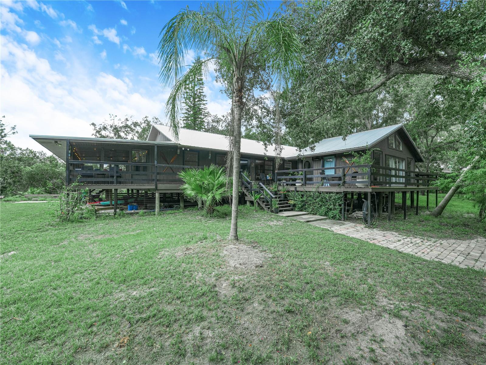 Imagine waking up to the gentle flow of the Peace River right outside your bedroom window.
This stunning 4-bedroom main home sits on 7.33 acres of pure Florida beauty, where deer stroll through the yard and nature surrounds you in every direction. It’s like living in the most luxurious summer camp imaginable—year-round.
Inside, no detail has been overlooked. Every inch is fully upgraded with exquisite finishes, blending rustic charm with modern comfort. When it can’t get any better, you discover the mother-in-law suite/guest house—perfect for visiting family, a private office, or even an Airbnb.
Whether you’re sipping coffee on the porch, kayaking down the river, or simply watching the wildlife, this is a home where nature meets luxury—and you get the best of both worlds.