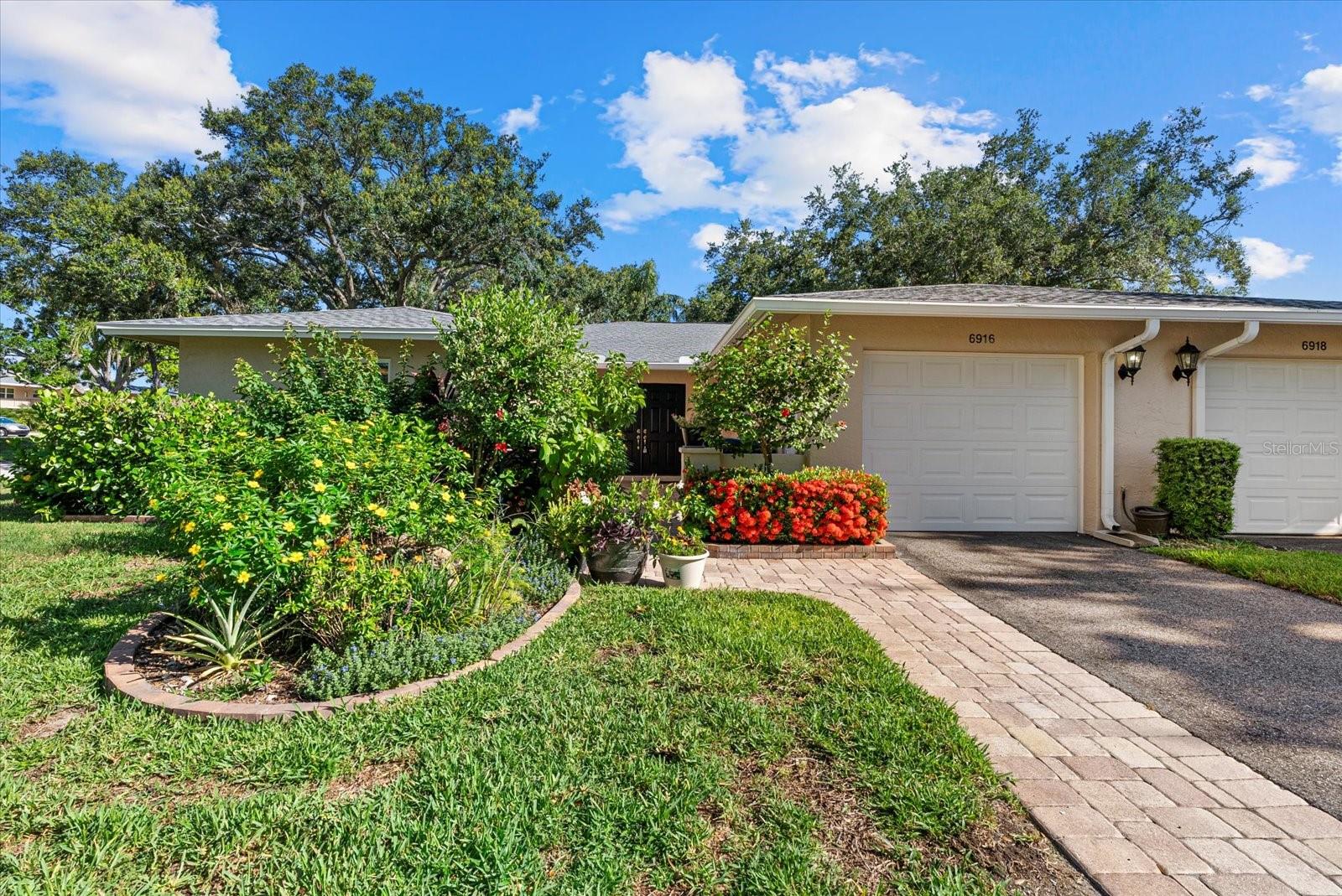 This beautifully renovated villa on a desirable corner lot in Fairway Point offers the ultimate in maintenance-free living just minutes from downtown Sarasota and the Gulf beaches. Step through the paved courtyard and double-door entry into a bright and open floor plan featuring neutral ceramic tile throughout and HIGH IMPACT windows and doors and NEWER ROOF for peace of mind.
The gourmet kitchen is a showstopper with solid wood cabinetry, rollout shelves, granite countertops, tile backsplash, and a sleek GE Café appliance package in matte white—including an undercounter beverage fridge—all new in 2022. The spacious living and dining areas flow into a sunny Florida room, perfect for entertaining or relaxing.
The primary suite boasts an oversized walk-in closet and a beautifully updated en-suite bath with handicap-accessible modifications. The second bedroom, office, and updated guest bath offer privacy and flexibility thanks to smart pocket doors.
Enjoy added features like indoor laundry, a 2020 A/C system, an oversized 1-car garage with epoxy floors and storage, and an expanded paver driveway.
Located just a golf cart ride away from the optional Palm Aire Country Club with two golf courses, pools, tennis, pickleball, fitness center, and dining, this home is also close to shopping, restaurants, SRQ Airport, medical facilities, and Sarasota’s top attractions.
Don't miss this move-in ready gem in one of Sarasota’s most sought-after communities!