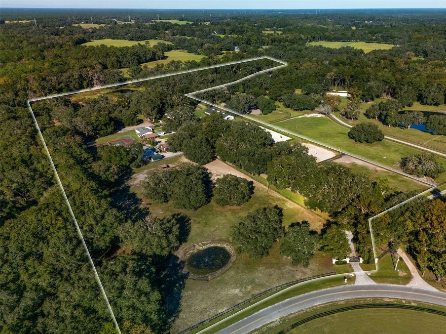 This 19+ acre fully fenced farm offers multiple living areas and the perfect setup for horses and riders, located less than 20 minutes from the World Equestrian Center. Majestic oak trees frame the landscape, creating a peaceful setting throughout the property. The main two-story residence features 3 bedrooms and 3 bathrooms, with the primary suite conveniently located on the main floor. A second home, a 3-bedroom, 2-bathroom mobile home, provides additional living space for guests, staff, or extended family. Adjacent to the second home are two additional rental units, a cozy studio with a bathroom and a comfortable 1 bedroom, 1 bathroom apartment, offering excellent options for income potential or on-site accommodations. Outdoor amenities abound, including an inviting inground pool and a private tennis court. The property is designed for serious equestrians, featuring two well-equipped barns, both with CEM-approved stalls and hot-water wash racks. The first barn includes 15 stalls, a tack room, and a feed room, while the second offers 8 stalls, a tack room, a bathroom, and an additional wash rack. Training facilities include a professionally constructed arena by Gentry Bulldozing, featuring a premium sand, fiber, and cloth footing mixture, along with a round pen. This property offers an outstanding opportunity for horse enthusiasts seeking a well-equipped and versatile farm.