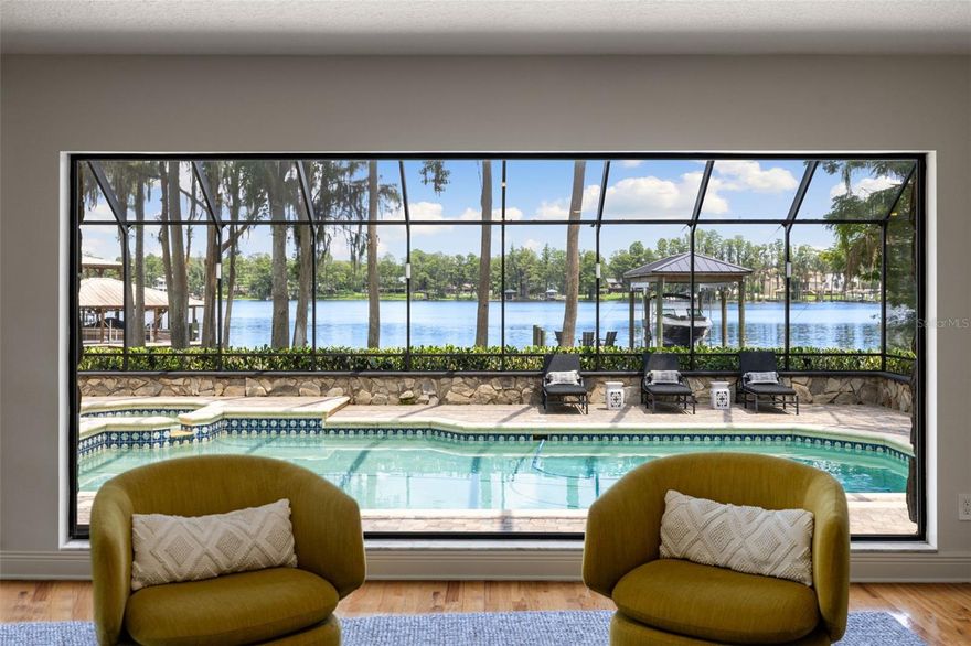 Under contract-accepting backup offers. Odessa’s Premier Lakefront Estate Awaits at 9116 Roberts Road, a breathtaking property on the coveted shores of Lake Keystone. Set on 1.74 acres with mature oak trees, lush landscaping, and a private beach offering 96 feet of lake frontage, this 4,637 sq. ft. estate showcases 4 bedrooms, 4 full baths, and 2 half baths, a true slice of paradise designed for both luxury living and entertaining. Step through the French doors into bright, inviting living spaces filled with natural light and sweeping views of Lake Keystone. Architectural details, dramatic windows, and timeless finishes create a refined yet welcoming atmosphere. The formal living room showcases a wood-burning fireplace framed by lake views, while just down the hall, a massive bonus room serves as the ultimate flex space, ideal as a media room, entertainment lounge, home gym, or more. Complete with its own wet bar, half bath, and direct access to the back patio, it’s a perfect extension of the home’s indoor-outdoor lifestyle. The chef’s kitchen, fully updated in 2019, features marble counters, Sub-Zero refrigeration, a Wolf gas range, and Culligan water filtration. Outside, the entertainer’s kitchen by the pool offers a built-in grill, Green Egg smoker, and under-counter refrigerator — an ideal setup for hosting gatherings. The formal dining room has been reimagined with striking, nearly floor-to-ceiling grid windows that create an architectural focal point, flooding the space with natural light while offering western exposure views of the landscaped yard. In the family room, a dramatic picture window frames a breathtaking panorama of the pool and lake, seamlessly blending the indoors with the outdoors.
Similar to the family room, a downstairs guest suite enjoys oversized windows with direct lake views and a private en suite bath. On the opposite wing, two additional bedrooms each feature their own en suite bathrooms, complemented by a laundry room with custom cabinetry, sink, and brand-new (2025) double Electrolux washer/dryers. Upstairs, the private primary suite offers a wood-burning fireplace, large walk-in closet with a center island, a renovated spa-like bathroom, and a private balcony overlooking the lake — complete with direct stair access to the pool. Additional recent upgrades include a brand-new tile roof (August 2025), full landscape lighting, and a new stone walkway leading to the dock and private beach. At the water’s edge, a hurricane-rated dock with a 10,000 lb. lift makes boating, fishing, and waterskiing effortless, while the 500-gallon propane tank ensures the home is well-equipped. Outdoors, the heated saltwater pool, re-screened lanai, and expansive entertaining areas provide the perfect backdrop for gatherings, while tranquil mornings and evenings on the shoreline deliver unmatched peace. Wake up to incredible sunrises and the ultimate lakefront lifestyle. This estate is more than a home—it’s lakefront living at its finest.