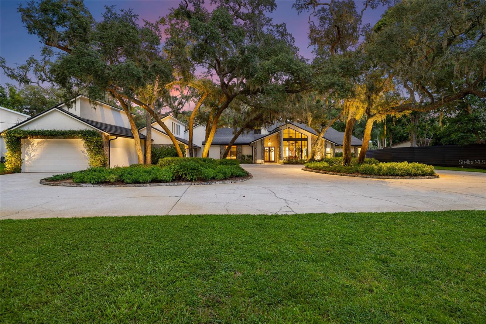 Odessa’s Premier Lakefront Estate Awaits at 9116 Roberts Road, a breathtaking property on the coveted shores of Lake Keystone. Set on 1.74 acres with mature oak trees, lush landscaping, and a private beach offering 96 feet of lake frontage, this 4,637 sq. ft. estate showcases 4 bedrooms, 4 full baths, and 2 half baths, a true slice of paradise designed for both luxury living and entertaining. Step through the French doors into bright, inviting living spaces filled with natural light and sweeping views of Lake Keystone. Architectural details, dramatic windows, and timeless finishes create a refined yet welcoming atmosphere. The formal living room showcases a wood-burning fireplace framed by lake views, while just down the hall, a massive bonus room serves as the ultimate flex space, ideal as a media room, entertainment lounge, home gym, or more. Complete with its own wet bar, half bath, and direct access to the back patio, it’s a perfect extension of the home’s indoor-outdoor lifestyle. The chef’s kitchen, fully updated in 2019, features marble counters, Sub-Zero refrigeration, a Wolf gas range, and Culligan water filtration. Outside, the entertainer’s kitchen by the pool offers a built-in grill, Green Egg smoker, and under-counter refrigerator — an ideal setup for hosting gatherings. The formal dining room has been reimagined with striking, nearly floor-to-ceiling grid windows that create an architectural focal point, flooding the space with natural light while offering western exposure views of the landscaped yard. In the family room, a dramatic picture window frames a breathtaking panorama of the pool and lake, seamlessly blending the indoors with the outdoors.
Similar to the family room, a downstairs guest suite enjoys oversized windows with direct lake views and a private en suite bath. On the opposite wing, two additional bedrooms each feature their own en suite bathrooms, complemented by a laundry room with custom cabinetry, sink, and brand-new (2025) double Electrolux washer/dryers. Upstairs, the private primary suite offers a wood-burning fireplace, large walk-in closet with a center island, a renovated spa-like bathroom, and a private balcony overlooking the lake — complete with direct stair access to the pool. Additional recent upgrades include a brand-new tile roof (August 2025), full landscape lighting, and a new stone walkway leading to the dock and private beach. At the water’s edge, a hurricane-rated dock with a 10,000 lb. lift makes boating, fishing, and waterskiing effortless, while the 500-gallon propane tank ensures the home is well-equipped. Outdoors, the heated saltwater pool, re-screened lanai, and expansive entertaining areas provide the perfect backdrop for gatherings, while tranquil mornings and evenings on the shoreline deliver unmatched peace. Wake up to incredible sunrises and the ultimate lakefront lifestyle. This estate is more than a home—it’s lakefront living at its finest. The home is zoned Agricultural. The 5 acre lot/pasture with the additional structure/garage directly in front of the listed property/house can be purchased, but is NOT included in the listing and has a separate Tax ID. The lot is also zoned Agricultural which provides the opportunity to own 6.8 Acres directly on Lake Keystone with the ability to enjoy horses, life on the lake, and add four additional garage spaces.