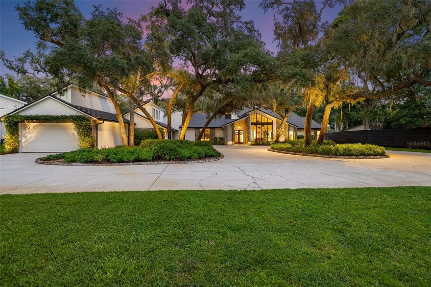 Odessa’s Premier Lakefront Estate Awaits at 9116 Roberts Road, a breathtaking property on the coveted shores of Lake Keystone. Set on 1.74 acres with mature oak trees, lush landscaping, and a private beach offering 96 feet of lake frontage, this 4,637 sq. ft. estate showcases 4 bedrooms, 4 full baths, and 2 half baths, a true slice of paradise designed for both luxury living and entertaining. Step through the French doors into bright, inviting living spaces filled with natural light and sweeping views of Lake Keystone. Architectural details, dramatic windows, and timeless finishes create a refined yet welcoming atmosphere. The formal living room showcases a wood-burning fireplace framed by lake views, while just down the hall, a massive bonus room serves as the ultimate flex space, ideal as a media room, entertainment lounge, home gym, or more. Complete with its own wet bar, half bath, and direct access to the back patio, it’s a perfect extension of the home’s indoor-outdoor lifestyle. The chef’s kitchen, fully updated in 2019, features marble counters, Sub-Zero refrigeration, a Wolf gas range, and Culligan water filtration. Outside, the entertainer’s kitchen by the pool offers a built-in grill, Green Egg smoker, and under-counter refrigerator — an ideal setup for hosting gatherings. The formal dining room has been reimagined with striking, nearly floor-to-ceiling grid windows that create an architectural focal point, flooding the space with natural light while offering western exposure views of the landscaped yard. In the family room, a dramatic picture window frames a breathtaking panorama of the pool and lake, seamlessly blending the indoors with the outdoors.
Similar to the family room, a downstairs guest suite enjoys oversized windows with direct lake views and a private en suite bath. On the opposite wing, two additional bedrooms each feature their own en suite bathrooms, complemented by a laundry room with custom cabinetry, sink, and brand-new (2025) double Electrolux washer/dryers. Upstairs, the private primary suite offers a wood-burning fireplace, large walk-in closet with a center island, a renovated spa-like bathroom, and a private balcony overlooking the lake — complete with direct stair access to the pool. Additional recent upgrades include a brand-new tile roof (August 2025), full landscape lighting, and a new stone walkway leading to the dock and private beach. At the water’s edge, a hurricane-rated dock with a 10,000 lb. lift makes boating, fishing, and waterskiing effortless, while the 500-gallon propane tank ensures the home is well-equipped. Outdoors, the heated saltwater pool, re-screened lanai, and expansive entertaining areas provide the perfect backdrop for gatherings, while tranquil mornings and evenings on the shoreline deliver unmatched peace. Wake up to incredible sunrises and the ultimate lakefront lifestyle. This estate is more than a home—it’s lakefront living at its finest. The home is zoned Agricultural. The 5 acre lot/pasture with the additional structure/garage directly in front of the listed property/house can be purchased, but is NOT included in the listing and has a separate Tax ID. The lot is also zoned Agricultural which provides the opportunity to own 6.8 Acres directly on Lake Keystone with the ability to enjoy horses, life on the lake, and add four additional garage spaces.