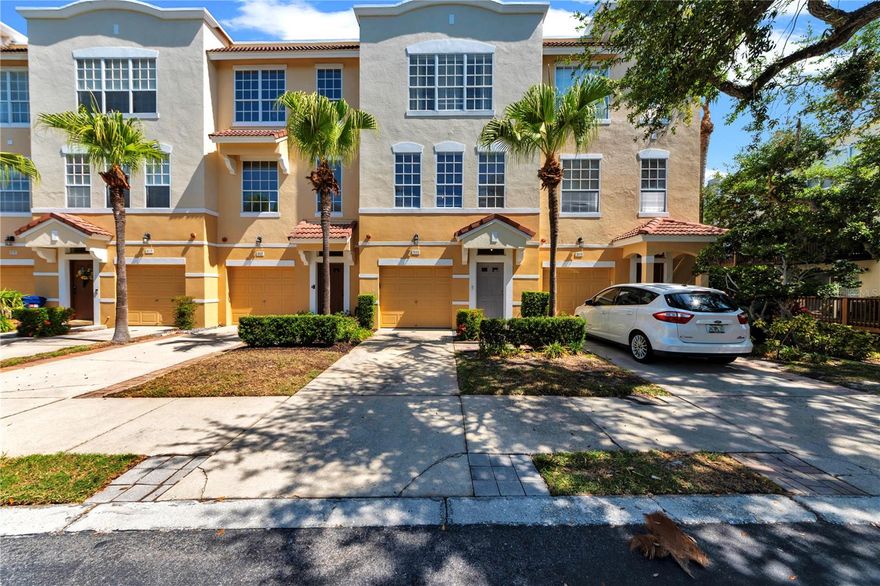 Perfect sized townhome in a colorful, quiet, gated community centrally located in Tampa Bay and in a very coveted part of South Tampa! With new paint and flooring throughout, we are move-in ready! This home offers plenty of space for a couple or even a family including parking for two cars right up front as well as community parking at each corner of the complex. Upon entering the home, the ground floor has a hallway leading to a large bedroom or bonus room with double closets which are connected behind the wall and a sliding glass door leading to a private, shaded patio. The ground floor bedroom is accompanied by it's own half bath right under the stairway. The stairs bring you up to an expansive great room that is sizeable enough to host your next soiree or family meals on the daily. The living room leads to a private balcony/ deck. The kitchen is equipped with stone countertops and extensive cabinetry including a pantry closet and BRAND NEW APPLIANCES! Another half bath is conveniently tucked in the corner of the kitchen. The third floor houses your primary bedroom on the north side, complete with double sink vanity en-suite and walk in closet. across from your primary bedroom is another bedroom with double closets, connected behind the wall, with its own full bathroom as well. Conveniently located between the two bedrooms is a laundry closet with plenty of space for cabinetry or storage and an included washer and dryer. Right behind your house you'll find the community pool complete with loungers, a pool shower, tables for meals, and community bathrooms, not to mention plenty of space to spread out. Don't expect any large expenses after closing as the HVAC system is only 3 years old and has been professionally maintained by a company monthly! The roof was just done by the HOA and is paid for! And the whole complex was termite tented within the last couple years to avoid any problems down the road!