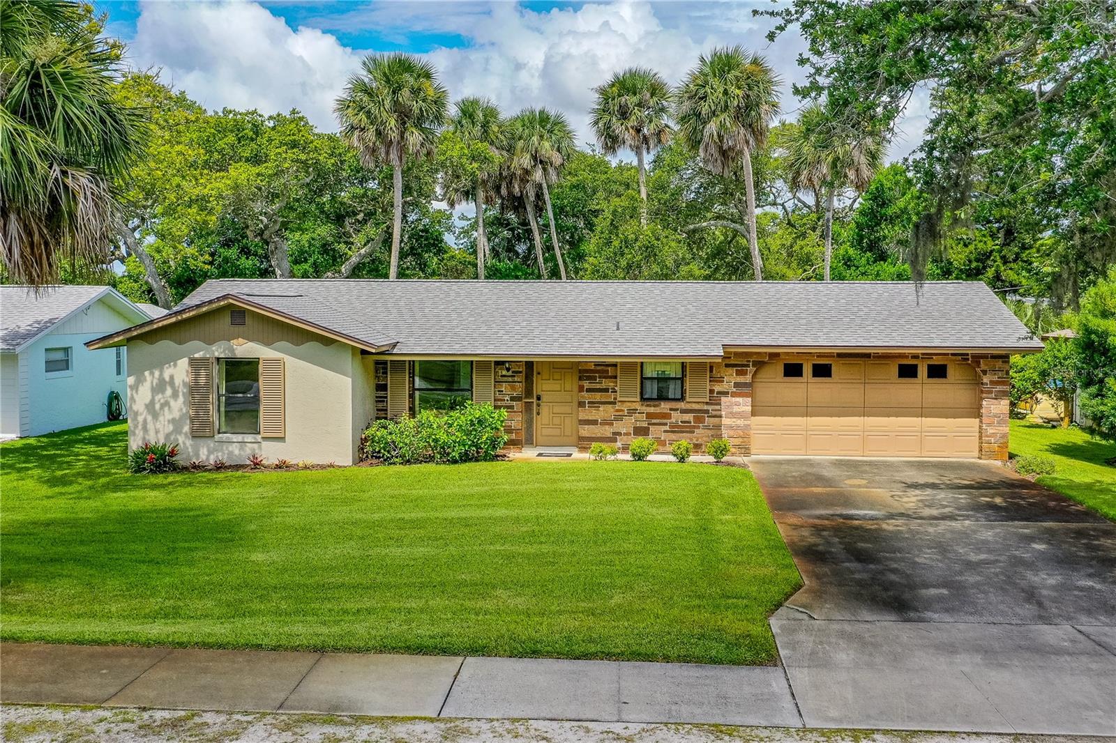 IF YOU ARE LUCKY TO LIVE IN NEW SMYRNA BEACH, YOU ARE LUCKY ENOUGH! THIS BEAUTIFUL HOME CAN MAKE YOU LUCKY ENOUGH. THIS MOVE IN READY HOME HAS BEEN IN THE SAME FAMILY FOR DECADES AND THE LOVE AND CARE THEY HAVE SHOWN IS APPARENT WHEN YOU DRIVE IN THE DRIVEWAY AND WALK IN THE FRONT DOOR. THIS GEM OF A HOME CENTRALLY LOCATED IN NEW SMYRNA BEACH WHICH IS KNOWN FOR ITS LAID-BACK VIBE, STUNNING BEACHES, WALKING AMENITIES ESPECIALLY AROUND FLAGLER AVENUE WHICH IS A HUB FOR DINING, SHOPPING AND ENTERTAINMENT. SITUATED ON A LARGE 75X140 LOT WITH LUSH PALM TREES AND BEAUTIFUL TREES THAT ADD TO THAT OLD FLORIDA FEELING. THIS SOLID BLOCK HOME WITH A RECENT ROOF (LESS THAN 5 YEARS OLD), NEW HVAC, GRANITE COUNTER TOPS - DURABILITY AND LOW MAINTENANCE ARE KEY FACTORS AND A BIG WIN FOR OWNING THIS REAL ESTATE INVESTMENT. THE BONUS ROOM WITH CATHEDRAL CEILINGS AND FLOOR TO CEILINGS WINDOWS OVERLOOKING A LUSH BACKYARD IS A DREAMY SPOT FOR RELAXING AND ENTERTAINING. THE OUTDOOR SHOWER AND GOLF CART FRIENDLY LOCATION SCREAM BEACH LIFESTYLE. THE FACT THAT ITS MOVE-IN READY MAKES IT APPEALING FOR RETIRES, VACATION HOME SEEKERS, OR INVESTORS LOOKING FOR A TURNKEY RENTAL PROPERTY. THE LARGE TWO-CAR GARAGE WITH WASHER AND DRYER, MOP SINK AND ADDITIONAL EXIT DOOR, SPRINKLER SYSTEM ON A WELL, AND PUBLIC UTILITIES ADD PRACTICALLY TO YOUR PURCHASE. THE 2-BED, 2-BATH LAYOUT WITH A SPACIOUS (25x14 ft) BONUS ROOM OFFERS FLEXIBILITY - MAYBE A HOME OFFICE, GUEST SPACE, OR MEDIA ROOM. NO FLOODING ISSUES FROM PAST STORMS LOCATED IN LOW-RISK FLOOD ZONE X. THIS MAGNIFICENT PROPERTY IS EASY TO SHOW. DON’T JUST DAY-DEAM ABOUT BEACH LIFE… JUST DO IT!