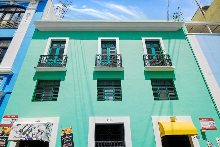 Live in the heart of Old San Juan in this beautifully designed and fully furnished second-floor apartment featuring soaring 17-foot ceilings that create a dramatic sense of space and light. Designed around an interior patio with expansive glass windows, the home is filled with natural light throughout the day, while original Spanish architectural details such as elegant arches blend seamlessly with an open floor plan for a unique and timeless design. The residence is finished with travertine stone floors, a European-style kitchen with modern appliances, and a built-in wine bar refrigerator, offering both comfort and sophistication. Quietly tucked away yet only half a block from Plaza de Armas, residents can enjoy immediate access to shops, cafés, restaurants, and even a SuperMax grocery store, making everyday living convenient and enjoyable. The apartment comes fully furnished for easy move-in, providing a stylish and functional space ideal for city living. Whether you’re seeking a private retreat, a home base while working remotely, or simply want to experience the history and charm of Old San Juan in comfort, this rare rental offers the perfect combination of historic character and modern amenities.