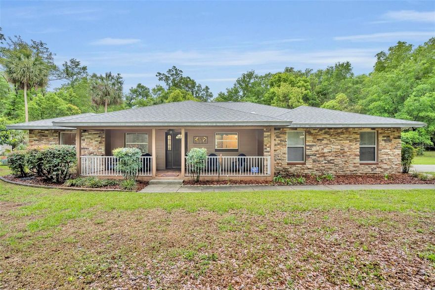 Welcome home to the Florida lifestyle you’ve been dreaming about. From the moment you arrive, the large, inviting front porch sets the tone—perfect for morning coffee, evening unwinding, or simply enjoying the neighborhood charm. Step inside to an open floor plan, highlighted by the vaulted ceilings, creating a spacious yet comfortable feel throughout. A front office offers the ideal work-from-home setup, while the thoughtfully designed split-bedroom layout provides privacy for everyone.

The heart of the home is the expansive family room, seamlessly connected to the kitchen—perfect for both everyday living and entertaining. French doors lead you out to the outdoor oasis, while a cozy cast iron stove adds warmth and character indoors. The kitchen itself is a standout feature, offering a large island with an extended breakfast bar, stainless steel appliances, stylish fixtures, and an abundance of counter and cabinet space. An adjacent dining area makes gathering easy and natural. The primary suite is generously sized, with plenty of room for a sitting area or dressing space. The en-suite bath is designed for relaxation, featuring a large soaking tub and separate shower. The additional bedrooms are also well sized and perfect for a growing family or guests. 

Step outside and you’ll truly see what Florida living is all about. The oversized covered patio opens directly to a fully screened-in pool and hot tub, creating a private retreat that’s ideal for entertaining or simply soaking up the sunshine. With a heated saltwater pool and spa, this outdoor space is ready to enjoy year-round. The outdoor space also features mature palm trees and a 31' x 16' raised garden bed, with an adjacent 10' x 12' garden shed. 

Additional updates and features include PVC piping, a new roof (2022), and new water heater (2020). The home also offers gas features including a fireplace and hot tub, supported by a 500-gallon gas tank. A detached garage with electrical adds extra flexibility for storage, hobbies, or workspace. There is also a 24' wide  x 25' deep RV shelter with a 30 amp outlet. This home blends comfort, functionality, and that unmistakable Florida lifestyle—don’t miss your chance to make it yours.