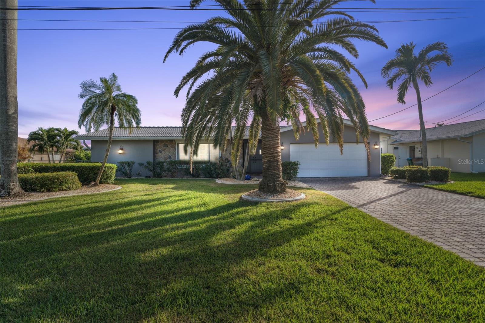Come experience exquisite Waterfront Living in this turnkey Gulf access gem! Discover the perfect blend of luxury, comfort, and convenience at 1904 SE 37th Street, a meticulously maintained 3-bedroom, 2.5 bathroom home in the highly desirable Savona Parkway neighborhood of Cape Coral. This property offers a rare combination of wide canal, direct Gulf access with no bridges, making it a boater’s paradise. Whether you're searching for your dream home or a lucrative investment, this turnkey property checks every box. From the moment you step inside, you'll be captivated by the high-end updates and attention to detail. The home features a sleek tile roof, energy- efficient windows, and stunning modern flooring throughout. The kitchen is a chef’s delight, boasting solid wood cabinetry, premium stainless- steel appliances, and ample counter space. Both bathrooms have been tastefully updated with stylish vanities and fixtures, providing a spa-like retreat. The outdoor living space is equally impressive featuring professionally manicured landscaping. Half of the seawall has been recently replaced, and a synthetic dock, complete with a 13,500 lb. boat lift—perfect for your boat and weekend adventures. Spend your days soaking up the Florida sunshine, fishing off the dock, or taking a leisurely cruise through the canals. Additional features include an oversized garage with a freshly epoxied floor and its own convenient half bath, ideal for storing vehicles, tools, and water toys. With all the big-ticket items already updated, including the AC, hot water heater, and more, you can move in with peace of mind and start enjoying the ultimate waterfront lifestyle from day one. Situated just minutes from Cape Coral’s vibrant downtown, you’ll have easy access to an array of dining, shopping, and entertainment options. Whether you’re relaxing at home or exploring everything the area has to offer, this home is the perfect coastal retreat. Don’t miss this extraordinary opportunity to own a slice of paradise. Schedule your private tour today!