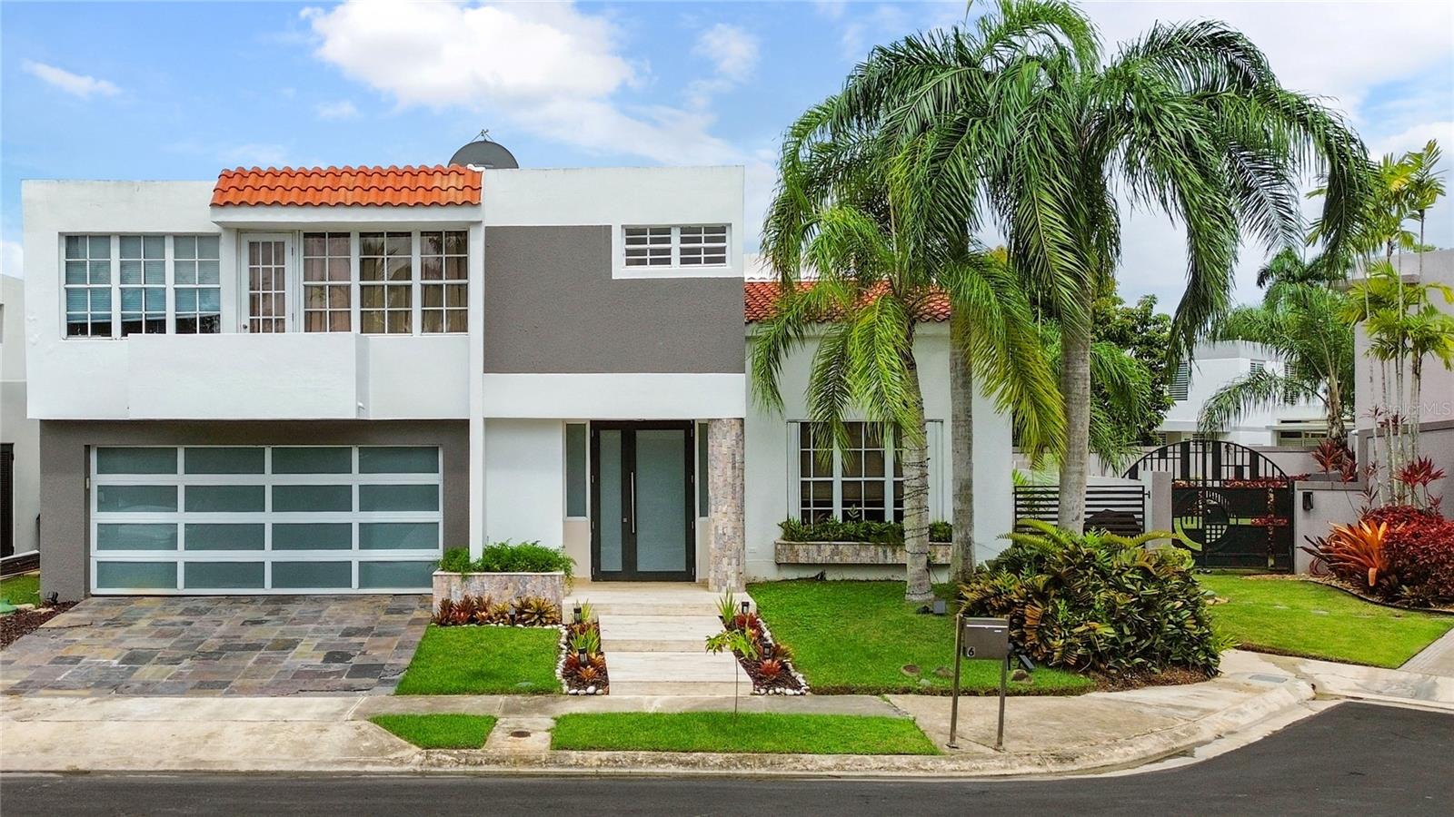 This glamorous property is located in a gated community in Guaynabo, Palma Real. This house sits on a 431sq mt lot and features aprox 2,900 square feet of living area. The modern floor plan integrates a spacious living room, dining room, family room and a gourmet kitchen. The residence boasts high ceilings, and doors and windows that allow plenty of natural light. Beautiful terrace and a lovely pool. Nice patio for outdoor activities. This home is ideal for family gatherings and entertainment. The gourmet kitchen is fully equipped with top-of-the-line appliances. Five bedrooms with four full bathroom bathrooms. The spacious master suite offers an ample master bathroom, a walking closet and a balcony. Two bedrooms share a full bathroom “jack and Jill”, and another bedroom is a Junior Suite with an en suite bathroom and a walking closet. The house boasts an extra bedroom with a full bathroom,” ideal for guest room or office”. This home offers a laundry area, linen closet and garage for two cars with storage, a powder room, and a spacious pantry area. For your convenience it also includes : Full Power Generator, Water Cistern, 7 a/c units, refrigerator, dishwasher, oven and microwave, stove top, hood and solar water heater. Gated community with 24/7 security guards, club house, with a Resort Style Swimming Pool, gym, playground,
tennis, basketball and volleyball courts. Conveniently located, close to private schools, shopping centers, restaurants. Call us today to coordinate a private showing. Don't miss this opportunity!