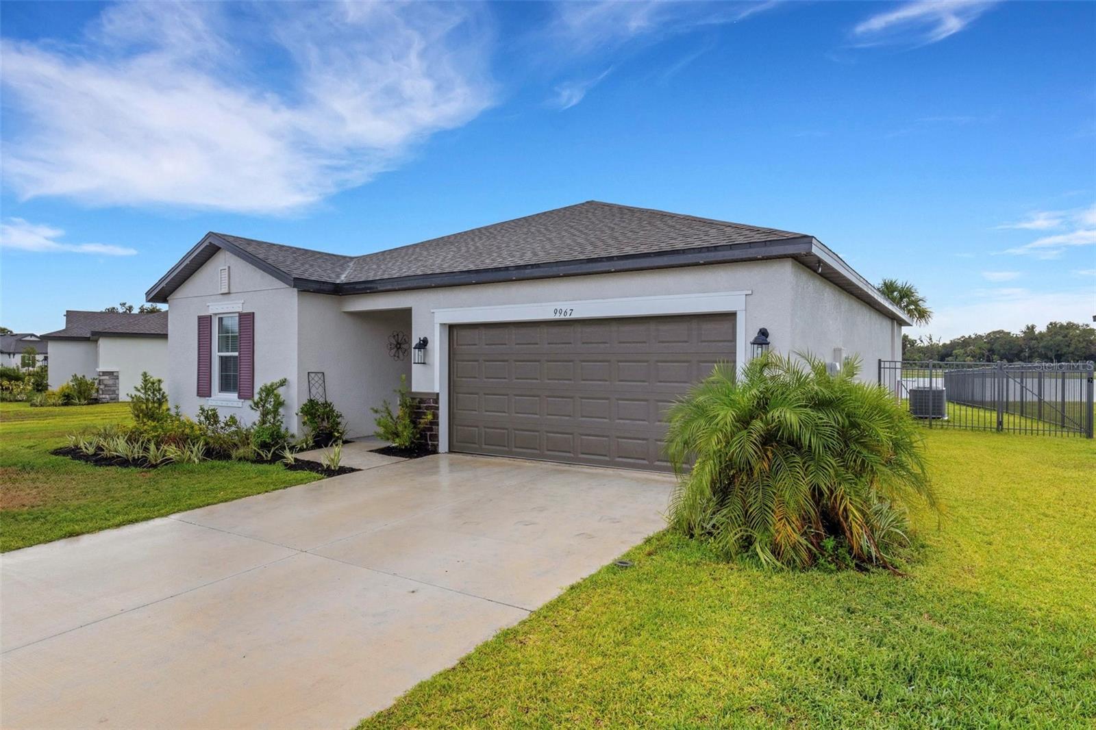 Welcome to this stunning home located in the gated cove of the Summerwoods community in Parrish! This spacious 3 bedroom, 2 bathroom residence features a thoughtfully designed split floorplan with many upgrades throughout. The open-concept living area showcases plank-style ceramic flooring, upgraded quartz countertops in all wet areas, and stainless steel appliances, offering both style and functionality. The primary suite includes a large walk-in closet and private bath, while the secondary bedrooms provide flexibility for family, guests, or a home office. Step outside to enjoy a fully fenced backyard with a serene water view, perfect for relaxing or entertaining. A two-car garage adds convenience and storage. Residents of Summerwoods enjoy access to resort-style amenities including a community pool, playground, and scenic walking trails. With its gated entry, this neighborhood offers both peace of mind and a strong sense of community. Ideally located just minutes from Lakewood Ranch, Ellenton, and Parrish’s growing shopping and dining options, with quick access to I-75 for commuting to Tampa, Sarasota, and St. Pete. This home combines modern upgrades, a peaceful water view, and the security of a gated community—making it the perfect place to call home.