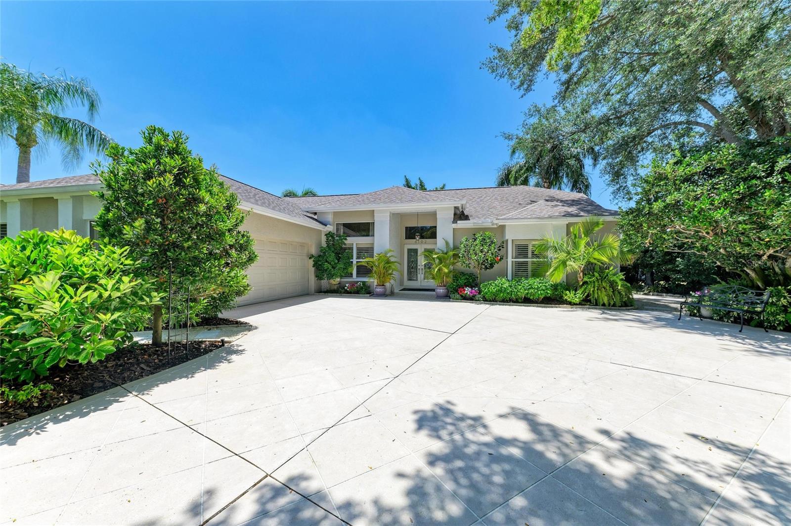 Discover your dream home nestled privately on a serene cul-de-sac, surrounded by mature landscaping. As you approach from the circular driveway, you’re taken with a sense of calm and tranquility. Step through the grand double doors into an impeccably maintained residence that exudes elegance and comfort; a true blend of classic design with thoughtful modern updates. This stunning 3-bedroom, 2-bathroom plus den home features an open and airy central living, dining and entertainment area with volume ceilings, separate primary suite and guest wings, all attached to the outdoor living areas throughfull width sliding glass doors; a truly unique and desirable floor plan.Indoors, the large living room is the center of the home with modern customwoodwork and a large home theatre. The updated designer kitchen is a chef's dream, with beautiful all-wood cabinetry, granite countertops and stainless steel appliances. The 15’ quartz island connects the kitchen and living area. It’s perfect for casual dining and to hang out while meals are being prepared. There’s a hidden coffee bar with mini fridge, a full pantry closet and a giant lighted pantry cabinet with generous pullout shelves. The formal dining room with large windows faces the pool and gardens for an elegant dining experience. The cozy den offers a private sitting area perfect for morning coffee or quiet reading. The laundry room contains matching cabinetry, pedestal mounted front loading washer and dryer. It’s attached to the two-car garage with ample floor to ceiling cabinetry. The primary retreat features a large bedroom with cozy sitting area opening to the pool deck. The luxurious bath is complete with double vanities, quartz ountertops, large glass-walled walk-in shower with six body jets, an oversized garden tub, and lots of natural light. The plantation shutters allow both plenty of light or plenty of privacy. And wait until you see the spacious mirrored cabinets in the custom walk in closet. Guests will enjoy a separate wing with comfy bedroom and upscale bath. An additional bedroom, presently used as a sewing/craft room, completes the guest wing. It features french doors that lead back into the dining room. Outdoors, you'll find a large, screened-in lanai, a sparkling spa pool with soothing fountain and numerous paths leading to private gardens, making it the perfect space for both entertaining and relaxation. The jetted pool has integrated seating all around. It’s small enough to heat quickly and perfect to enjoy beverages in a hot bubbling oasis. The pool is totally private from neighbors and the incorporated privacy screen creates a dramatic background of gigantic palm trees framed by spectacular sunsets. This exterior beauty is seamlessly integrated with the central living area through the fully retractable sliding glass doors. This spectacular home features new interior doors and hardware to complete the exquisite blend of classic and modern style. Updated roof, HVAC, water heater and pool equipment make this a worry-free investment in future living. Situated in River Club in Lakewood Ranch, enjoy an 18-hole championship golf course, driving range and clubhouse, low HOA fees and NO CDD’s. Near I-75, Sarasota/Bradenton International Airport, and the UTC shopping and dining district, this home offers the perfect blend of luxury and convenience. Don't miss this rare opportunity to own an amazing home in one of the area's most desirable neighborhoods! Schedule your private tour!