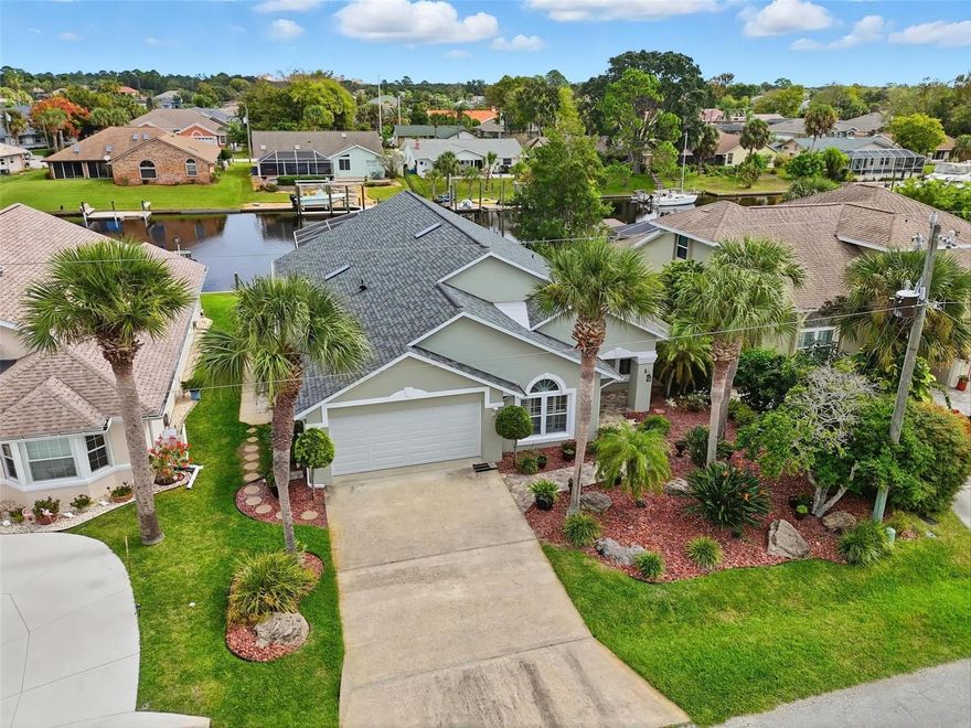 Your Direct-Access Waterfront Paradise Awaits in Palm Coast!  Live the ultimate Florida lifestyle at 82 Cochise Court! This exceptional waterfront home is a boater's dream, perfectly situated on a wide, navigable canal with no fixed bridges, offering quick and easy access to the Intracoastal Waterway.  Your private backyard oasis is an entertainer's delight. Spend your days lounging by the sparkling swimming pool or heading out on the water from your private dock, complete with a boat lift.  Step inside to an impressive 2,088 square foot open floor plan that flows effortlessly, featuring durable and stylish tile and laminate flooring throughout—no carpet! The spacious central kitchen is perfect for gathering, featuring sleek solid surface counters and a full suite of stainless steel appliances.  This home offers true flexibility with four generous bedrooms.  The private master suite provides a tranquil retreat with its own ensuite bath.  Peace of mind is built-in. This home is secured with a BRAND NEW 2024 ROOF and is ready for any weather with a whole-house generator hookup. A two-car garage provides ample storage for your vehicles and coastal toys.  Don't miss this rare opportunity to own a move-in-ready, direct-access waterfront home. Your boat belongs here! Schedule your private showing today.
