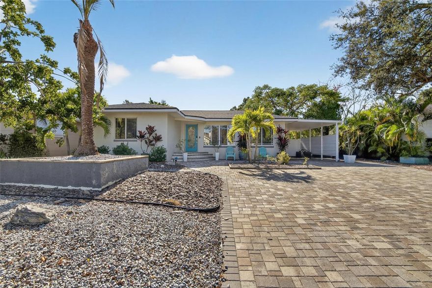 CHARMING GULFPORT HOME with a CASITA and a POOL. Literally, down the street from Stetson University College of Law. The brick paved street with a beautifully landscaped median coupled with this home's tropical landscaping and oversized paved driveway is ever so inviting. The transformation of this property is a must see! Once inside your eyes will be drawn to the blonde hardwood flooring in the formal living room. All bedroom closets have been customized for maximum storage. Both the primary bath and guest (full) bath's tile work is most impressive. Wedgwood blue kitchen cabinets are striking next to the stainless steel appliances, dishwasher and refrigerator recently upgraded. The butcher block island makes meal preparation/serving an ease with the adjoining formal dinning room. Continue your entertaining into the spacious family room or step outside to relax by the pool with a very generous area for seating or unwind in the hot tub. To further enhance your entraining, a casita is in your backyard. Provide your guest with the detached suite that features a vaulted ceiling, one bedroom, a full bathroom, a living room with french doors and a kitchenette. The roof was replaced in 2022 and the backyard is completely fenced. While this home is tucked in a gorgeous neighborhood it is also conveniently located: cyclist and runners will enjoy picking up the Pinellas Trail just 10 blocks north of the home, beachgoer's will appreciate less than a 5 minute drive to Gulfport Beach or a 10 minute drive to St Pete Beach, and travelers are thrilled that Tampa International Airport is 30 minutes away. This home has it all, location and charm.