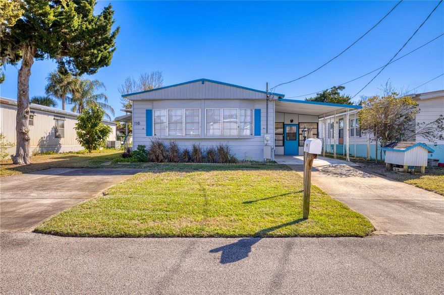 Enjoy true WATERFRONT living in this NEWLY REMODELED manufactured home situated on a CANAL lot with a concrete seawall, BOATHOUSE, and BOAT LIFT.  The canal offers direct access to the Indian River Lagoon, home to some of the best saltwater fishing on the East Coast - perfect for boaters and anglers alike!  Step inside to a bright, open layout filled with natural light from a wall of windows spanning the entire front of the home.  The home has been thoughtfully updated with a durable metal roof, new paint, vinyl plank flooring, a new kitchen featuring quartz countertops and stainless GE appliances.  Both bathrooms have been tastefully renovated offering modern finishes and comfort.  Outdoor living shines here with a composite deck, paver patio area and walkway, an enclosed porch, covered patio, workshop and shed.  The property also includes a private well and irrigation system, making lawncare easy and cost effective. A carport and two driveways provide plenty of parking for vehicles, boats, or guests.  Located in Edgewater, just minutes from New Smyrna Beach, you'll love the easy access to charming coastal restaurants, shopping and schools.
