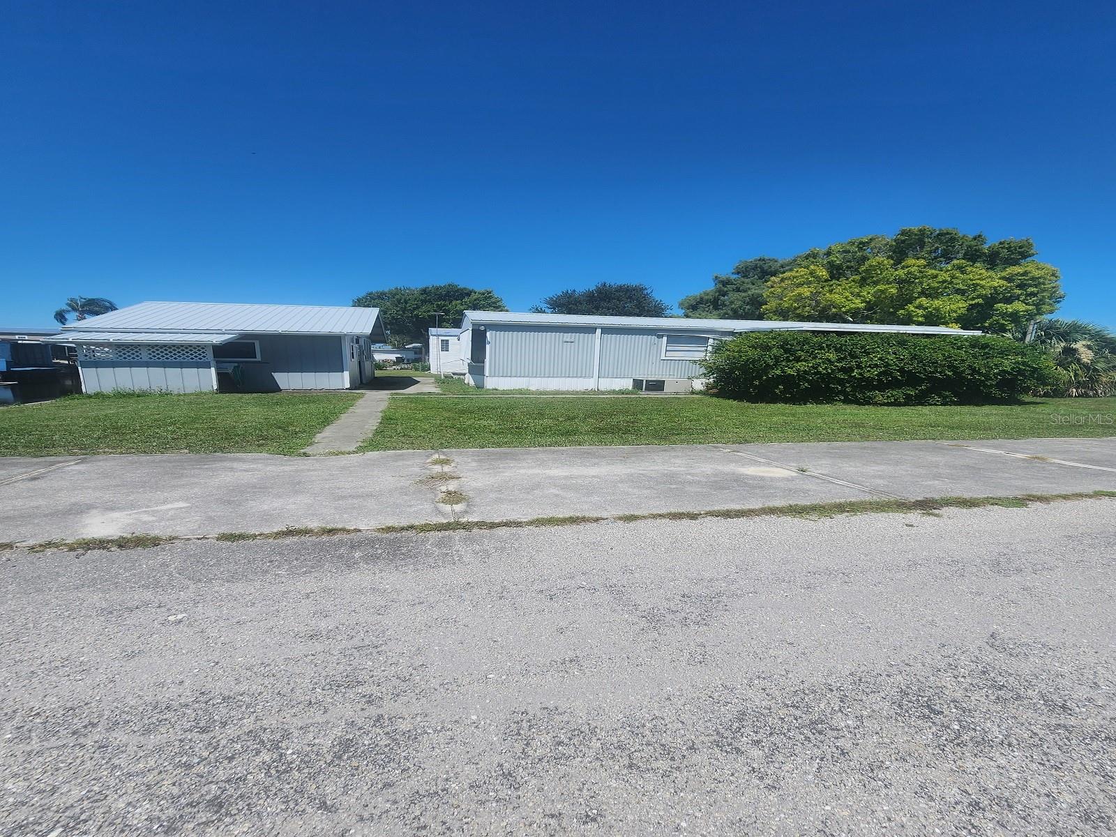 LAKE OKEECHOBEE ACCESS/ CANAL ACCESS- 2 bedroom 1-Bathroom mobile home with attached carport. This comes with a Boathouse included, it is perfect for someone who loves fishing. There is canal frontage, CANAL/ LAKE OKEECHOBEE ACCESS!! This property is located minutes from town, in a quiet neighborhood. Call today for more information! All measurements are approximate, buyers must measure for exact dimensions.